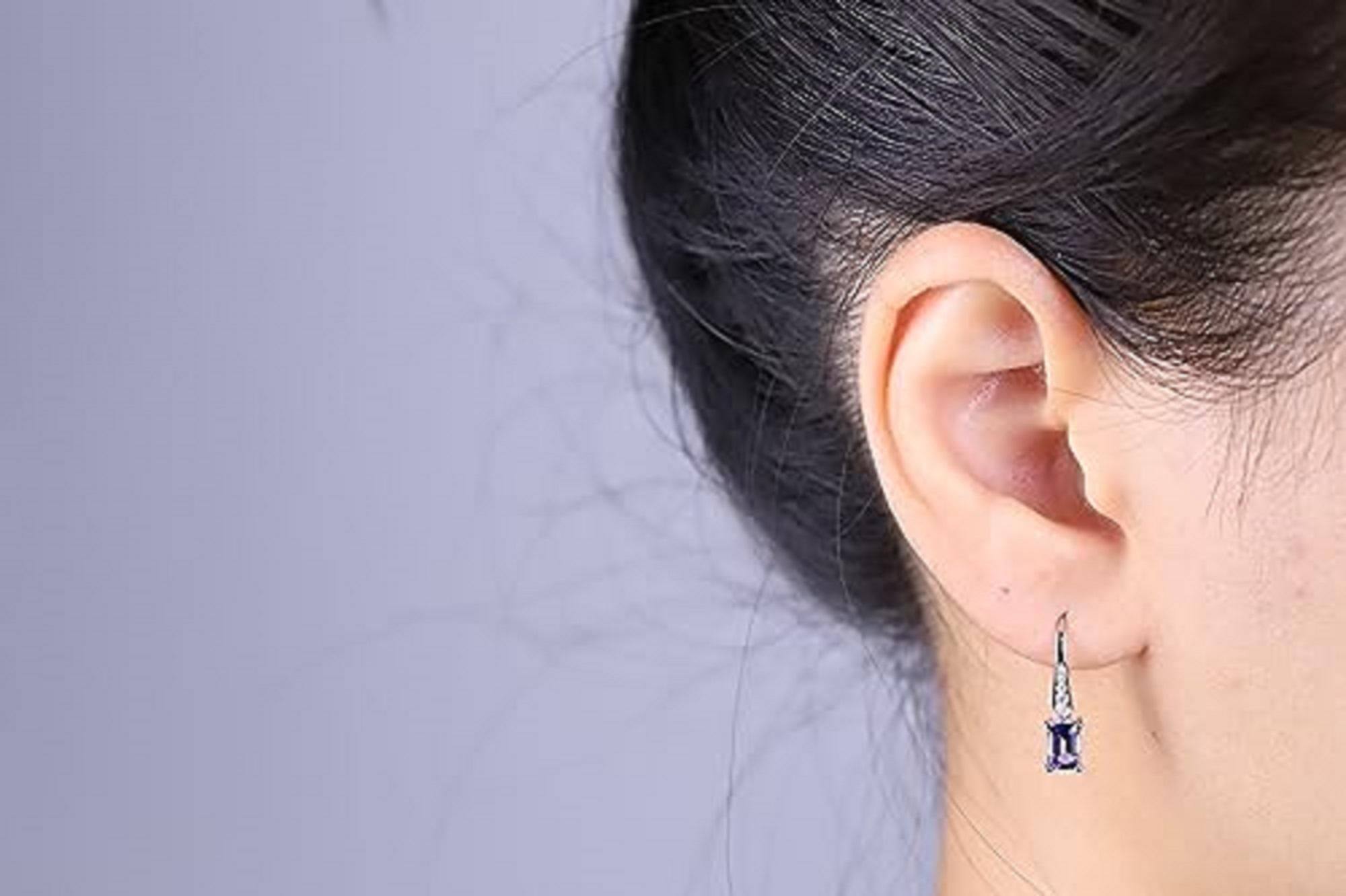 Decorate yourself in elegance with this Earring is crafted from 14-karat White Gold by Gin & Grace Earring. This Earring is made up of 4*6 Tanzanite emerald-cut (2 Pcs) 1.22 Carat Round-Cut Prong setting White Diamond (10 Pcs) 0.13 Carat. This