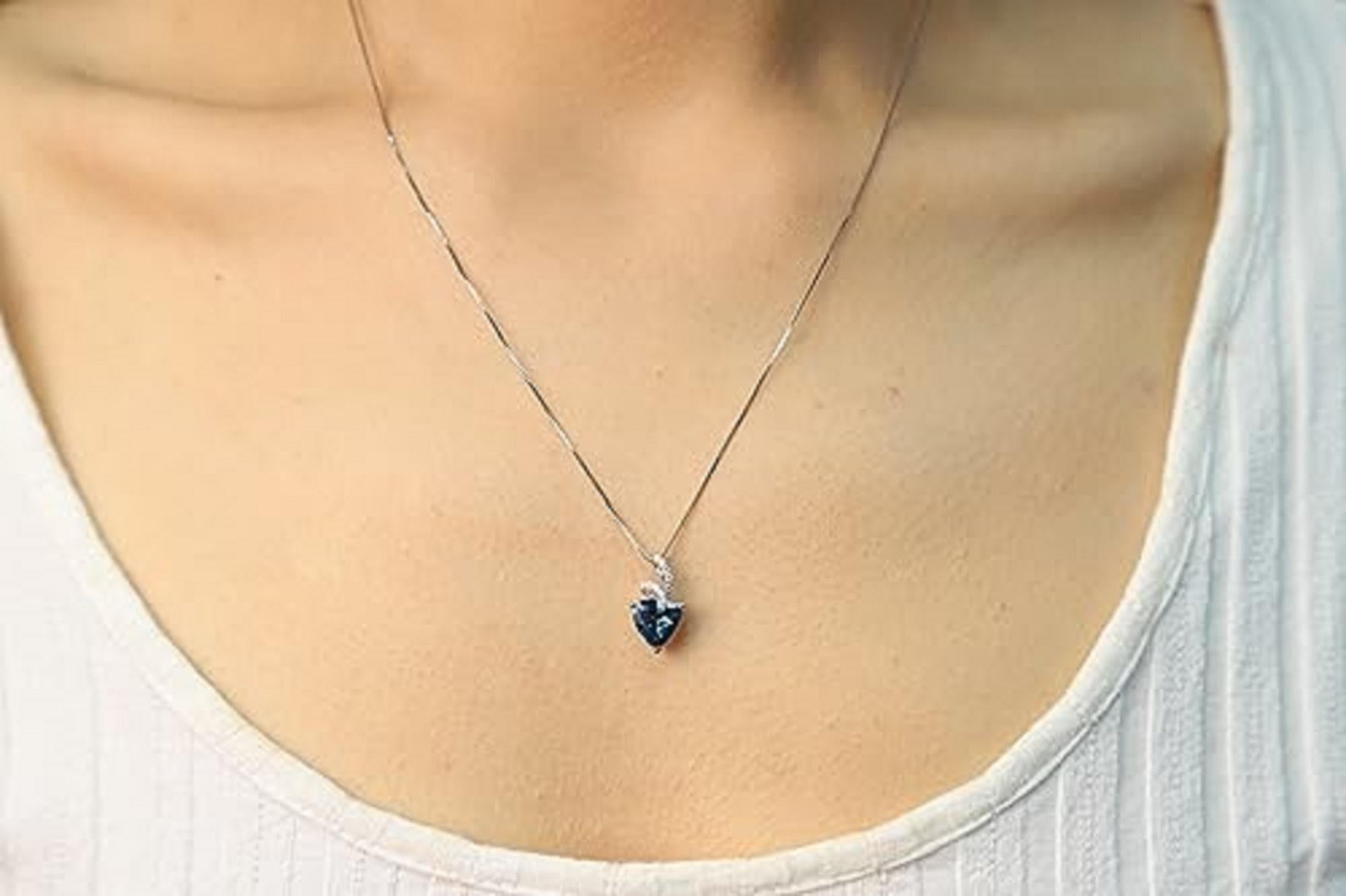 Decorate yourself in elegance with this Pendant is crafted from 14-karat White Gold by Gin & Grace Pendant. This Pendant is made up of 8mm Trillion-cut Prong setting Tanzanite (1 Pcs) 1.88 Carat and Round-Cut Prong setting White Diamond (12 Pcs)