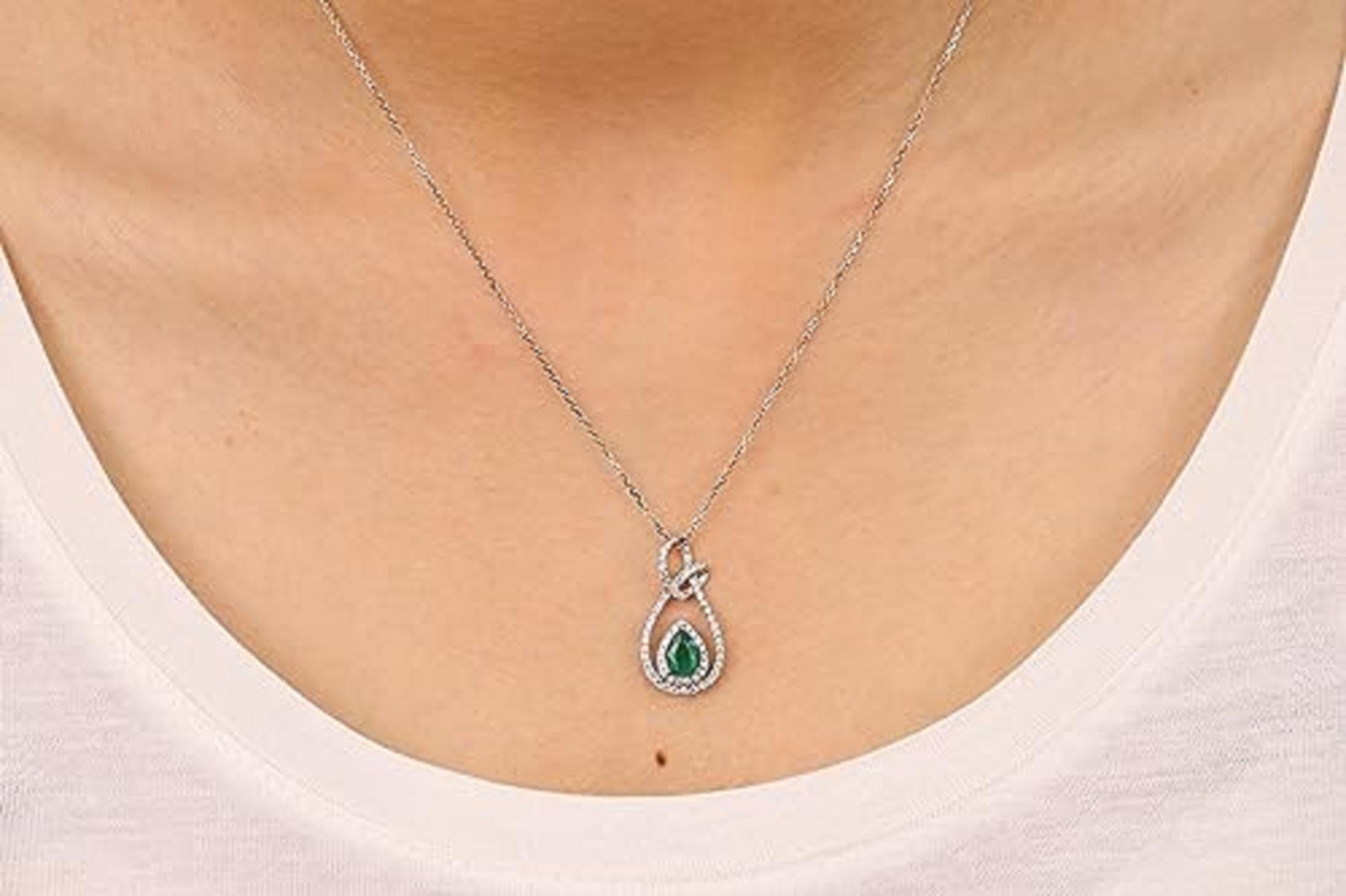 Decorate yourself in elegance with this Pendant is crafted from 14-karat White Gold by Gin & Grace. This Pendant is made up of 7x5 mm Pear-Cut Emerald (1 pcs) 0.65 carat and Round-cut White Diamond (67 Pcs) 0.36 Carat. This Pendant is weight 2.81