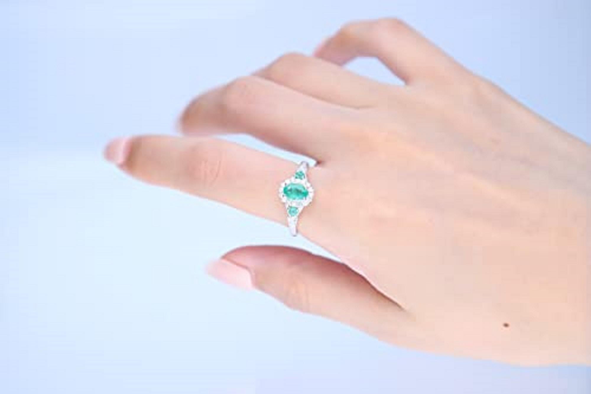 Decorate yourself in elegance with this Ring is crafted from 14-karat White Gold by Gin & Grace. This Ring is made up of 7x5 mm Oval-Cut Emerald (1 pcs) 0.72 carat, 2.5 mm Round-cut Emerald (2 pcs) 0.13 carat and Round-cut White Diamond (26 Pcs)