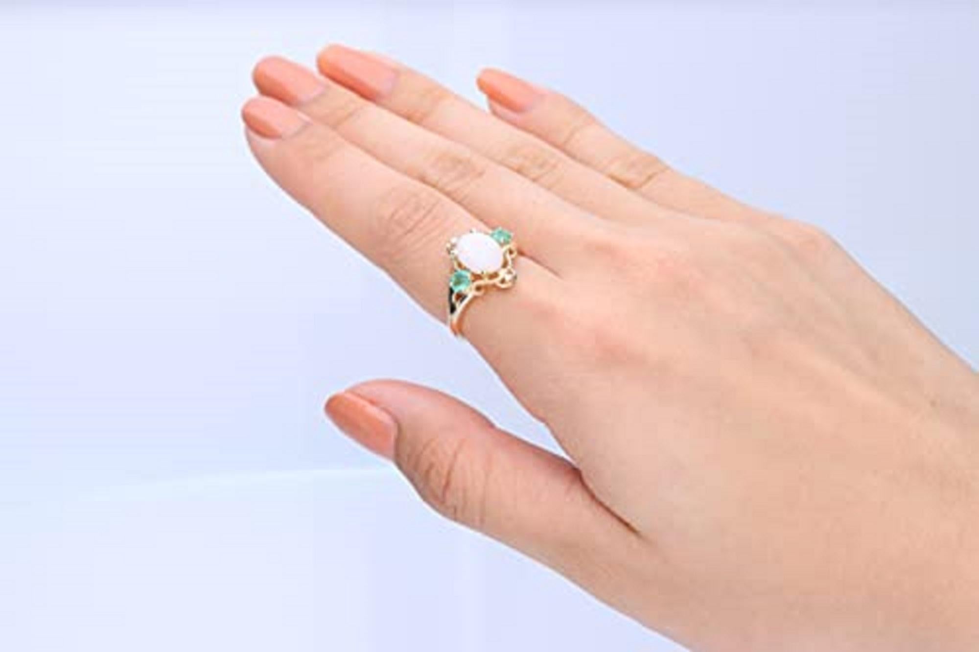 Decorate yourself in elegance with this Ring is crafted from 14-karat Yellow Gold by Gin & Grace. This Ring is made up of 7*9 (Oval-Cut) Australian opal (1 pcs) 1.11 carat, 3*4 oval-cut Emerald (2 Pcs) 0.32 carat and Round-cut white diamond (2 Pcs)