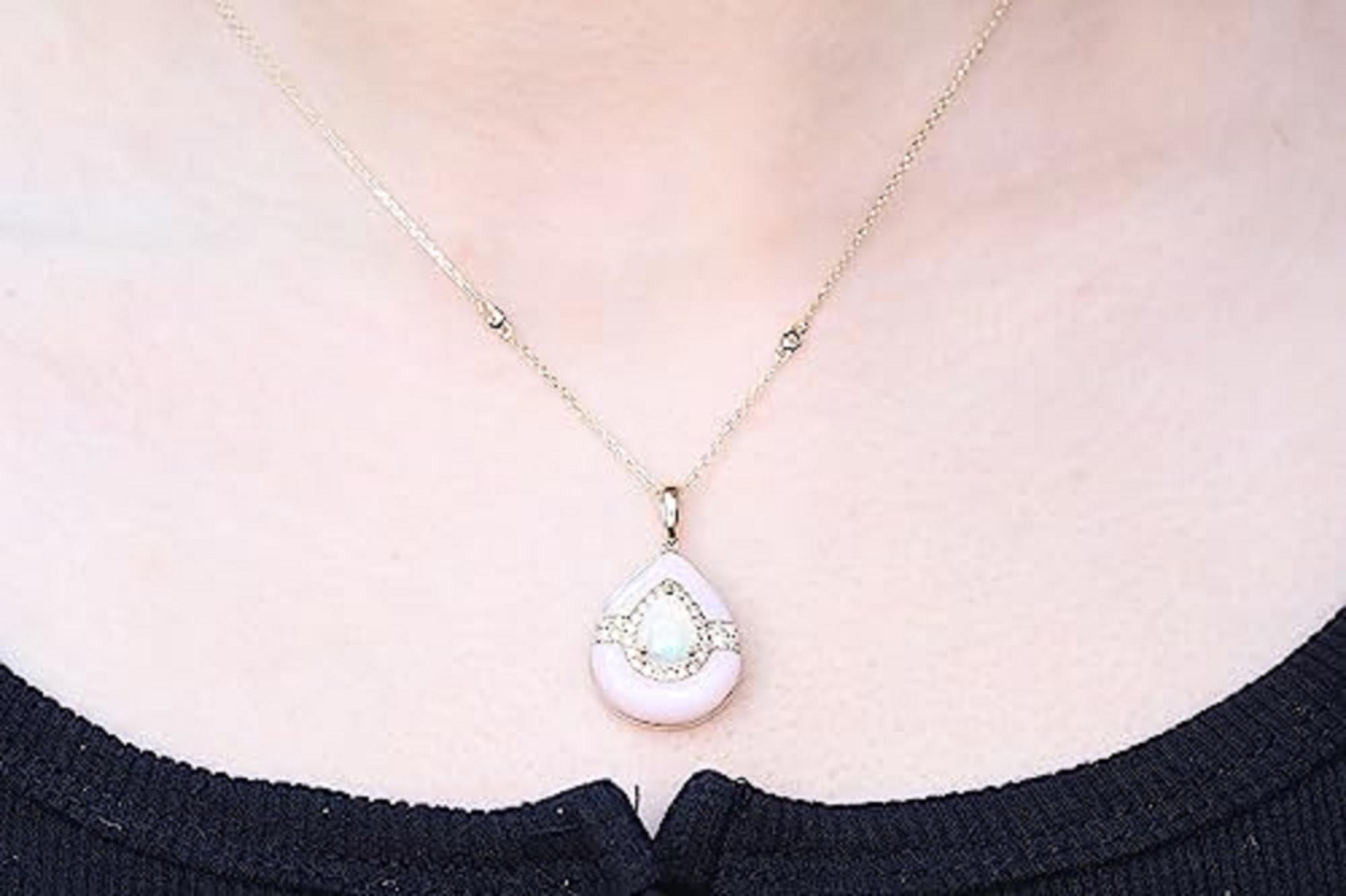 Decorate yourself in elegance with this Pendant is crafted from 14-karat Yellow Gold by Gin & Grace. This Pendant is made up of 7*9 Pear-cut Ethiopian Opal (1 pcs) 0.96 carat, Pink Opal free mix (2 Pcs) 3.86 carat and round-cut White Diamond (35