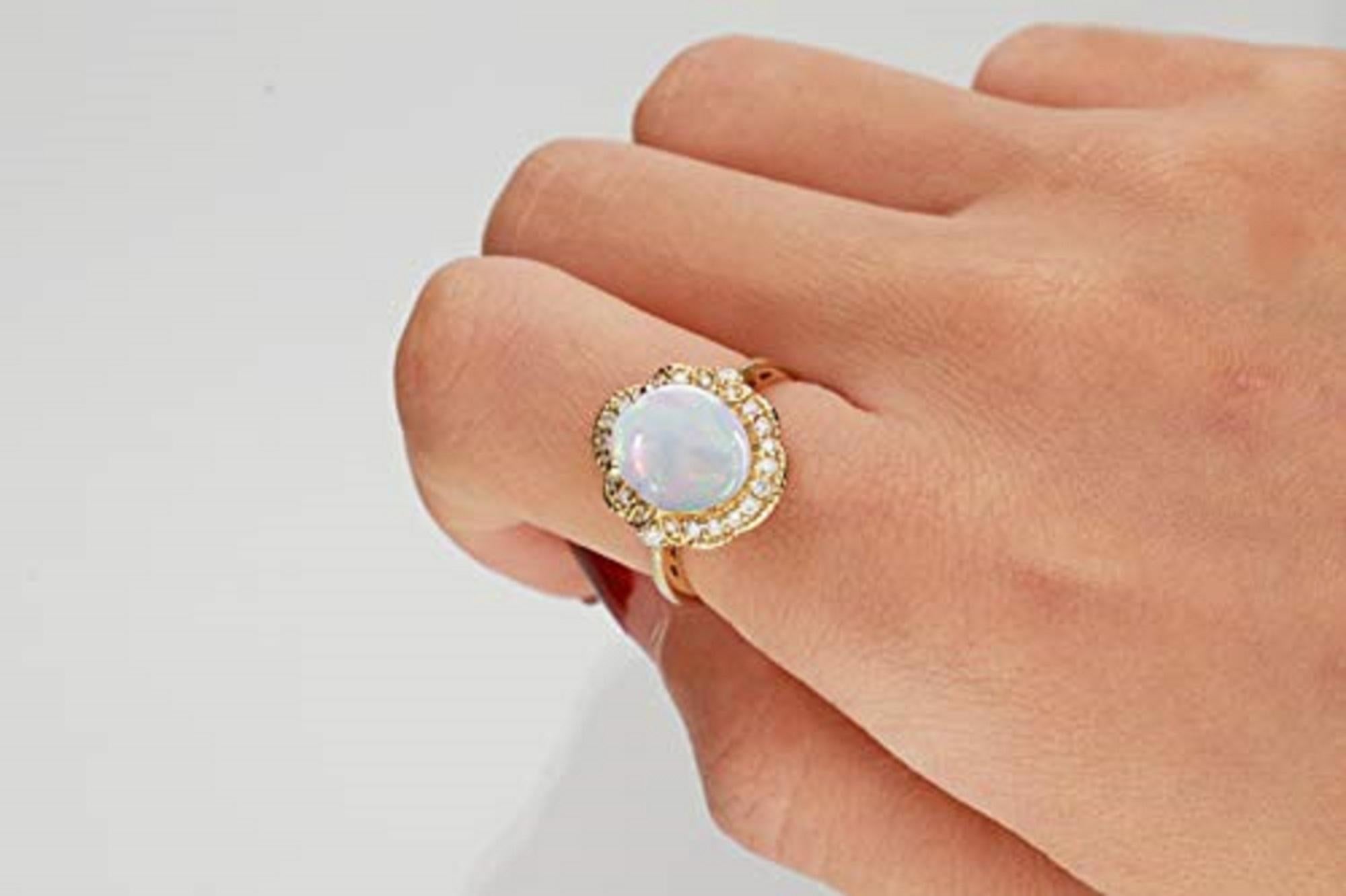 Give her this unique, regal jewelry from Gin & Grace. A colorful display and chic design showcases Natural opal gems and glistening diamonds. The pretty ring is gleaming and made of 14k yellow gold. Gemstone colors: White Gemstone shapes: Oval-cut