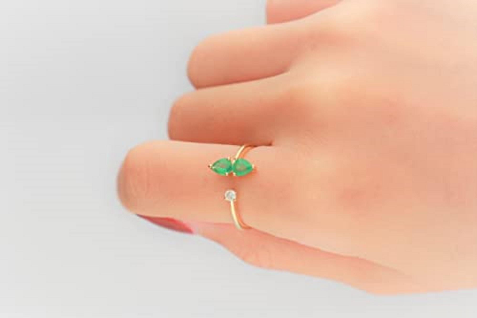 Decorate yourself in elegance with this Ring is crafted from 14-karat Yellow Gold by Gin & Grace. This Ring is made up of 4*5 Emerald pear-cut (2 pcs) 0.56 and Round-cut Diamond (1 pcs) 0.07 Carat. This Ring is weight 1.80 grams. This delicate Ring
