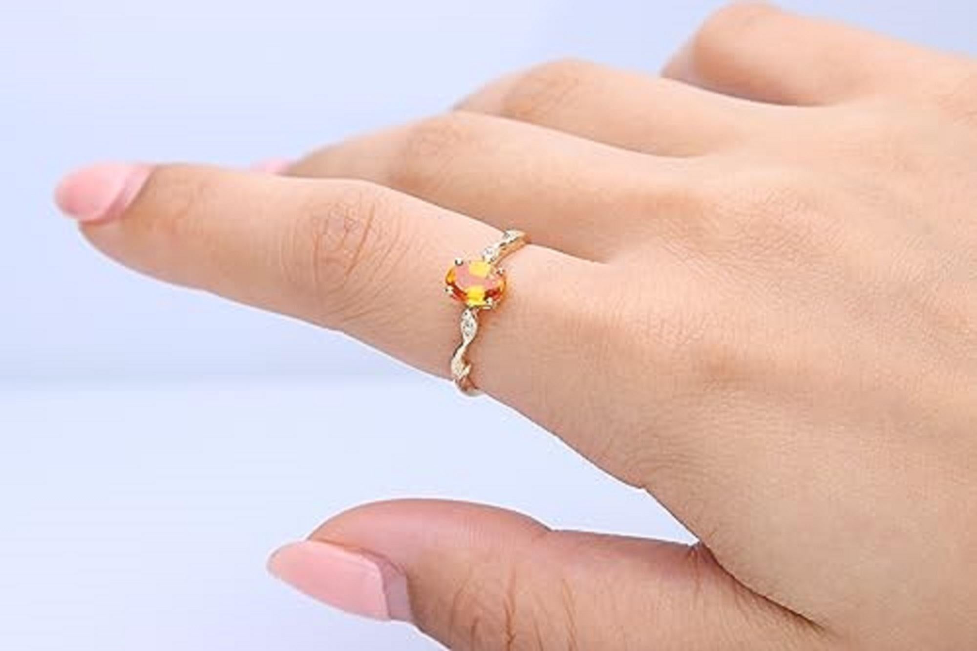Decorate yourself in elegance with this Ring is crafted from 14-karat Yellow gold 5*7 Oval-cut Spessartite (1 pcs) 1.16 carat and round-cut white diamond (4 pcs) 0.03 carat. This Ring is weight 1.78 grams. This delicate Ring is polished to a high