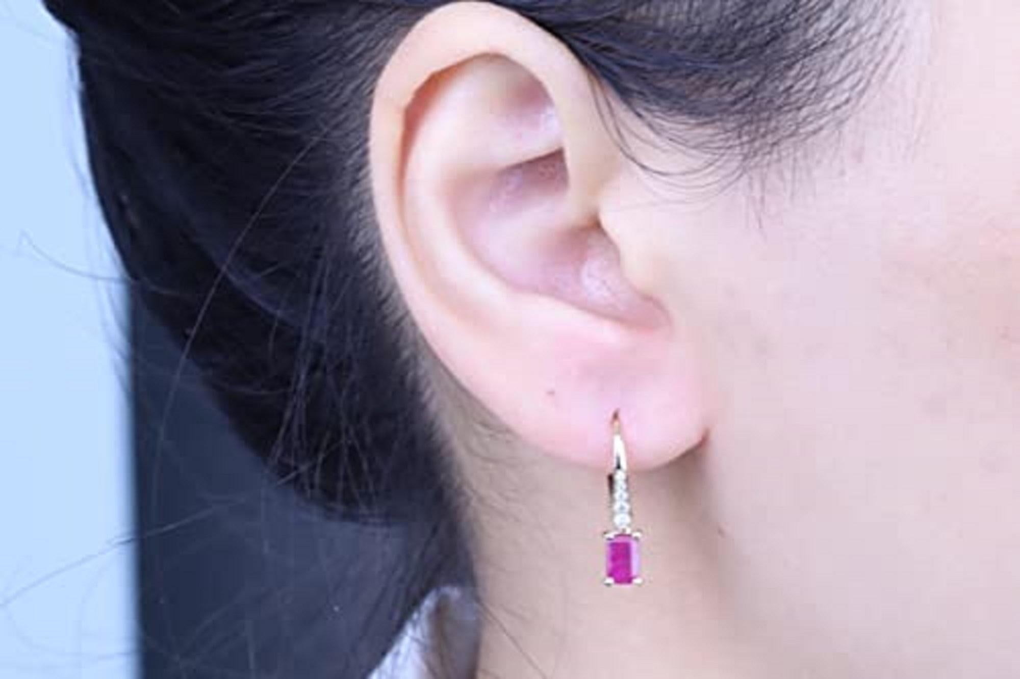 Decorate yourself in elegance with this Earring is crafted from 14-karat Yellow Gold by Gin & Grace. This Earring is made up of 4X6 Round ruby (2 pcs) 1.140 carat ,Round-cut White Diamond (10 Pcs) 0.132 Carat. This Earring is weight 1.63 grams. This