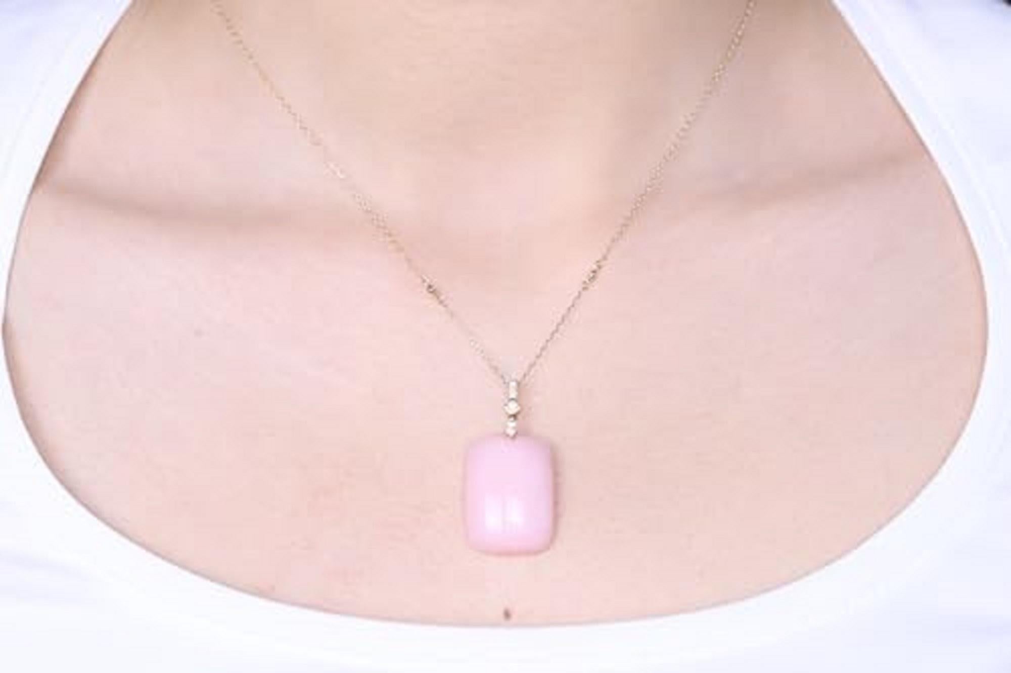 Decorate yourself in elegance with this Pendant is crafted from 14-karat Yellow Gold by Gin & Grace. This Pendant is made up of 18*25 Cushion-cut Pink opal (1 Pcs) 24.08 carat and round-cut white Diamond (8 pcs) 0.08 carat. This Pendant is weight