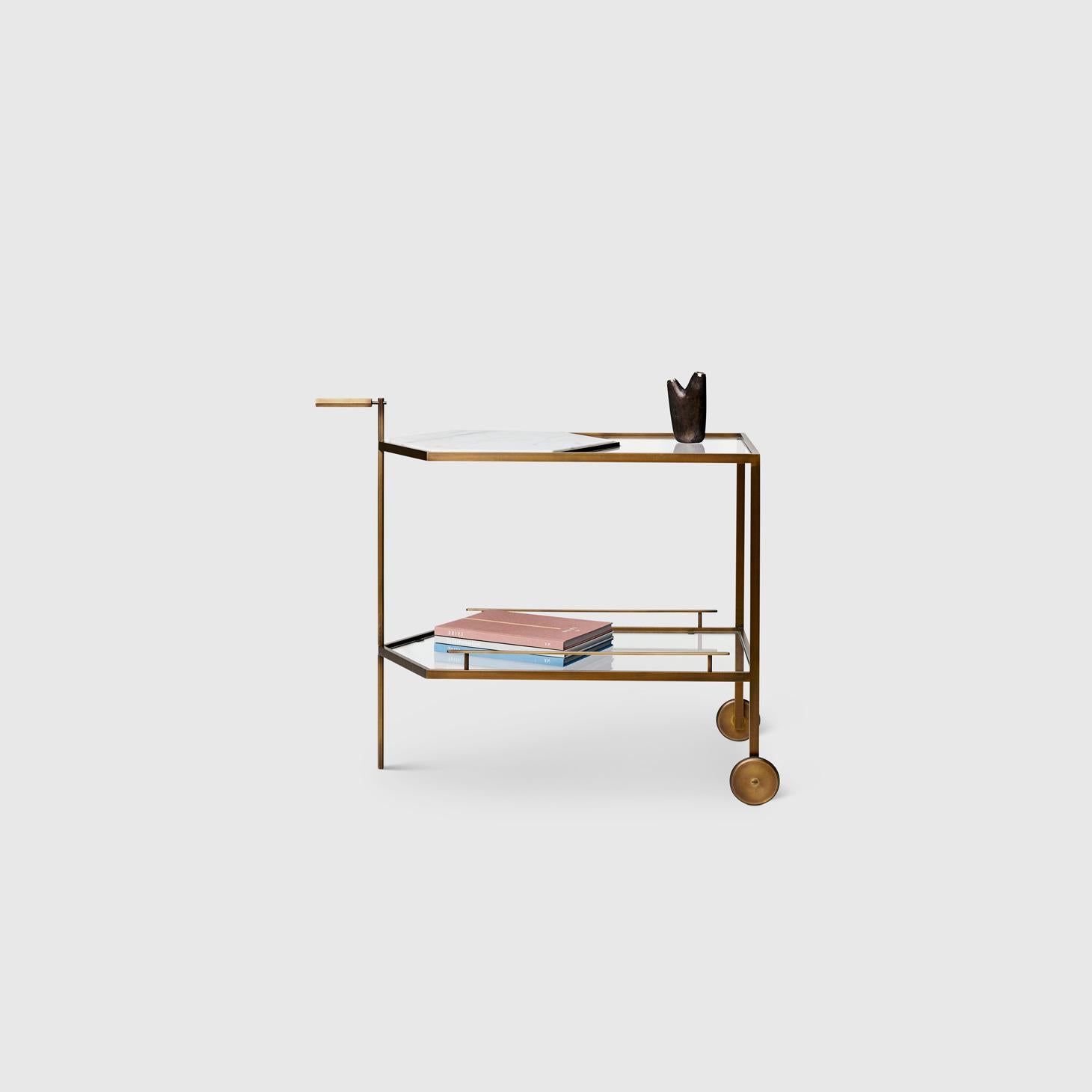 The Gin Lane bar cart by Yabu Pushelberg has a minimal profile in Smoked Bronze paired with Calacatta marble or Smoked Brass paired with Carrara marble. The simple profile takes precision craftsmanship by experts in Italy and creates a statement