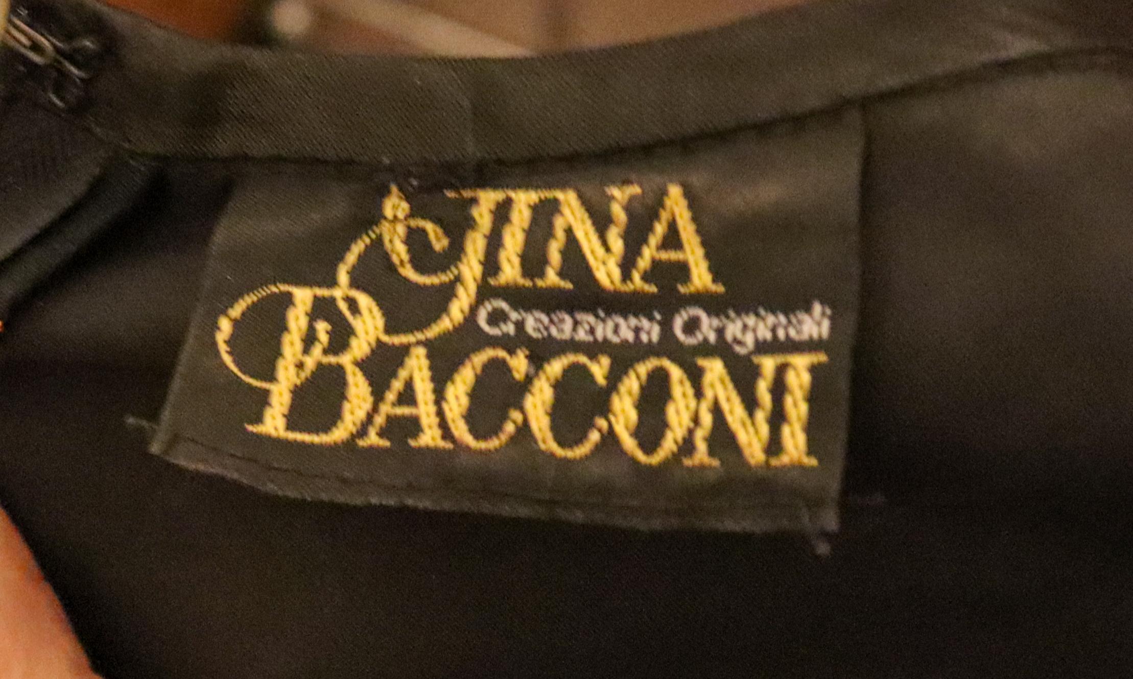 A stunning vintage evening top by Gina Bacconi. The top has a black background with different colour lurex rectangles.  It has a zip back opening, and is fully lined.  Outer fabric 70% viscose 30 % metallic. Old size 14  , Measurements