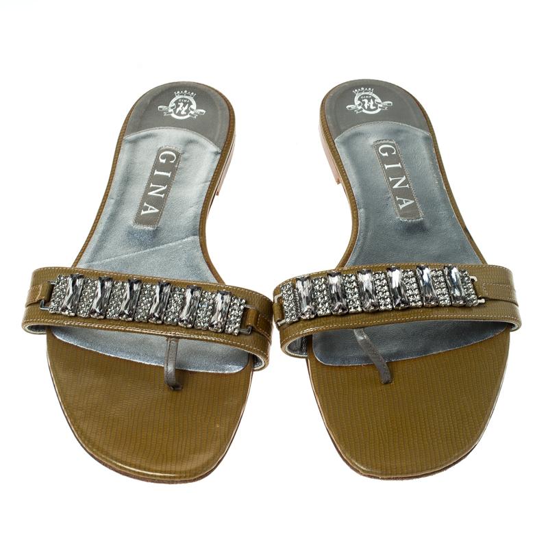 Wear these Gina sandals for a sparkling look. They feature a crystal embellished, patent leather strap on the vamps coupled with leather lining. Comfortable to wear all day long, they will raise your style quotient manifolds.

Includes: The Luxury