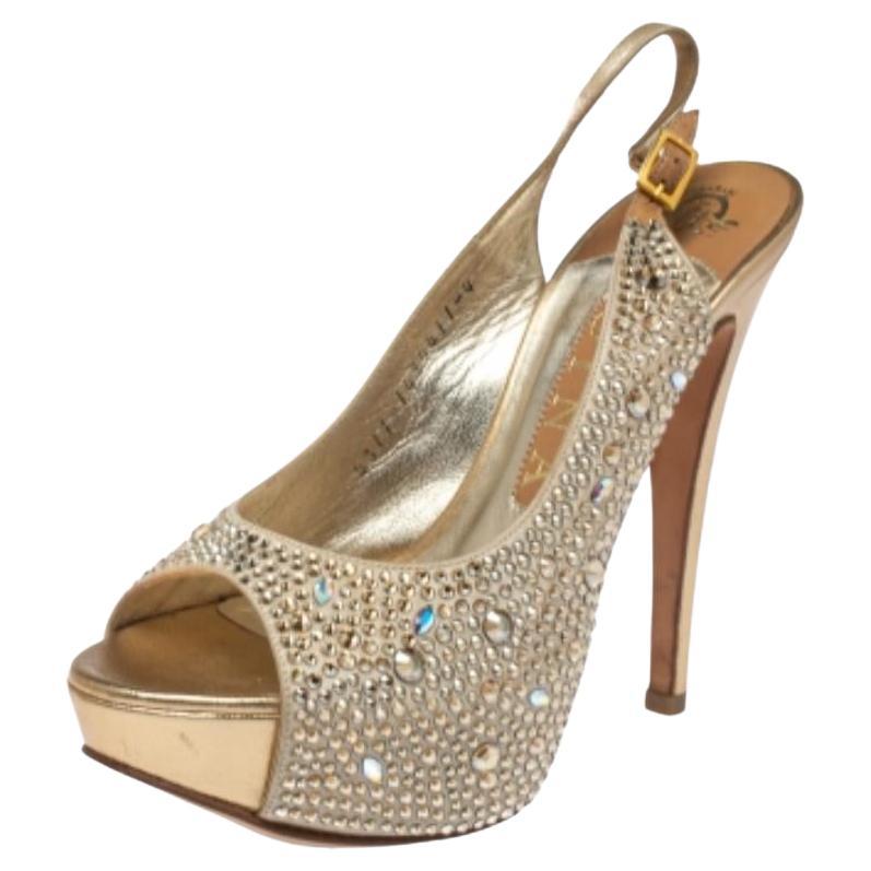 Brimming with elegance and beauty, these Gina sandals will instantly amp up your evening ensemble. Crafted from beige-hued satin into a peep-toe silouette, they are embellished with artfully placed crystals all over the exterior. The sandals are