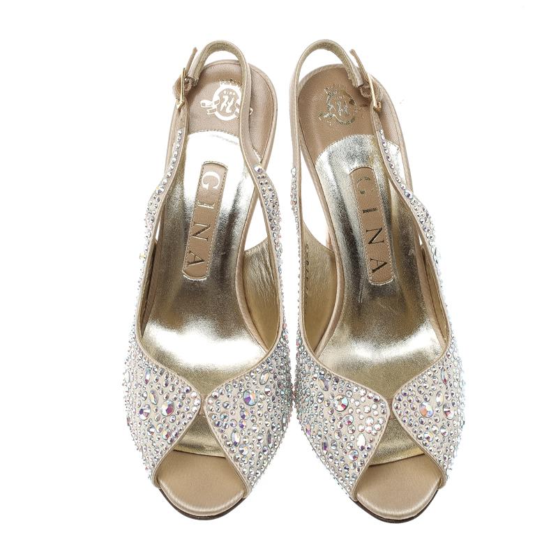 You'll be all set to shine with style in these dazzling Gina sandals. They are covered in crystals and designed with slingbacks, peep toes and 11 cm heels. These sandals are sure to attract admirers!

Includes: Original Dustbag, Original Box, Info