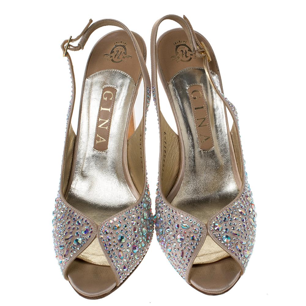 Get your hands on these gorgeous sandals from Gina! They are crafted from satin and feature pretty, crystal embellishments all over. They flaunt slingback straps and come equipped with comfortable leather-lined insoles and high heels.

