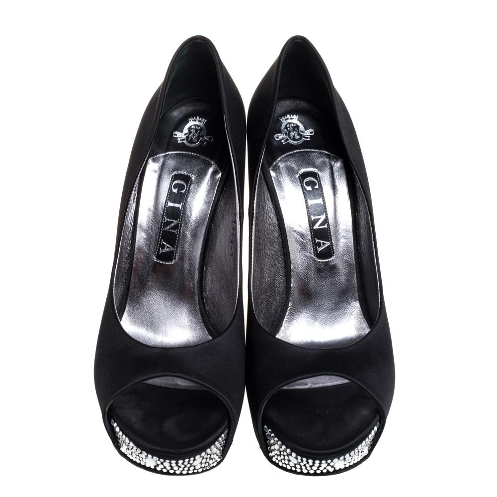 Look stunning in this pair of crystal embellished pumps from Gina. The black satin pumps have a wedge heel and open toe style. Easy to slip on, they have a comfortable leather-lined insole. The Belle pumps can be teamed up with evening wear.

