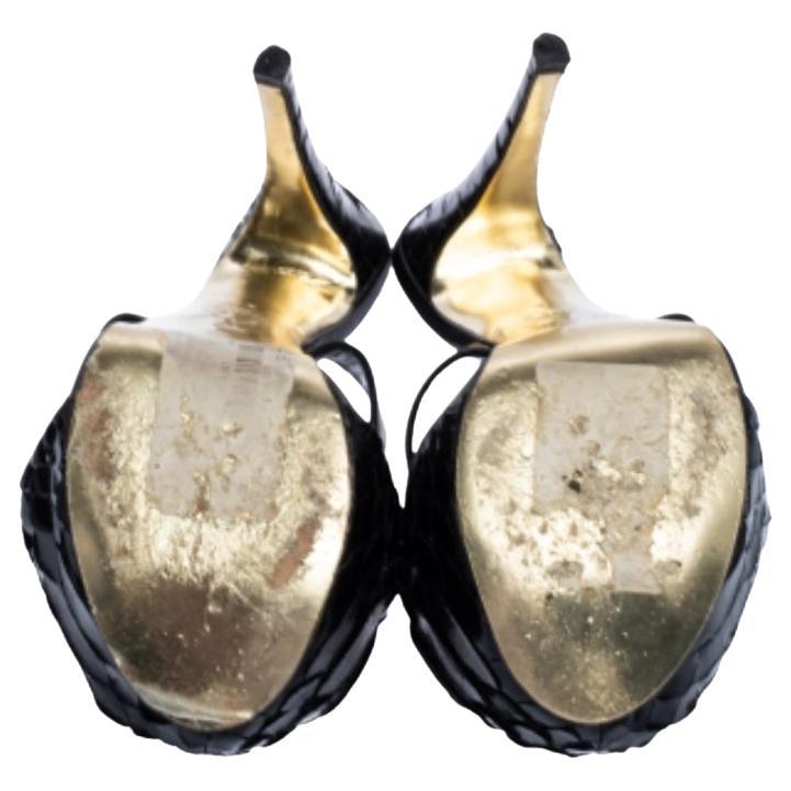 Flaunt your love for fashion when you wear these sandals from Gina. These leather and python sandals flaunt a unique design with closed toes and towering stiletto heels. These black sandals will accentuate and compliment your outfit. (Note: