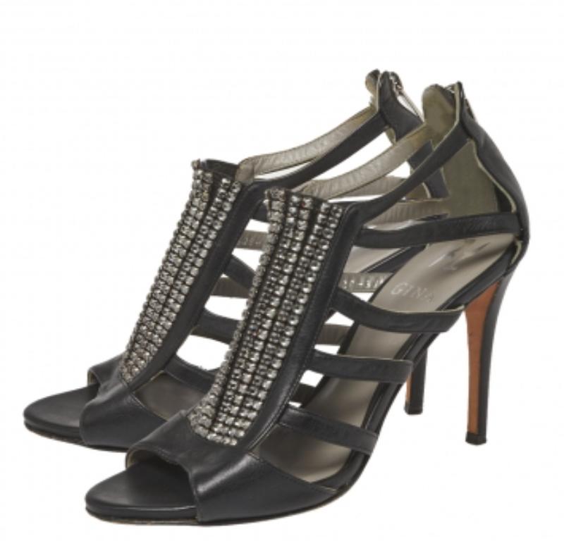 Wear these sandals by Gina for your evening parties and notice admiring glances coming your way. Crafted from black leather, they feature crystal-embellished panels on the vamps, a strappy layout on the sides, and open toes. The rear zipper pulls,
