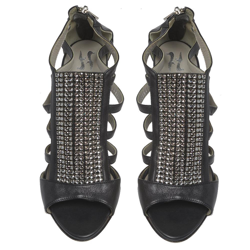 Wear these sandals by Gina for your evening parties and notice admiring glances coming your way. Crafted from black leather, they feature crystal-embellished panels on the vamps, a strappy layout on the sides, and open toes. The rear zipper pulls,