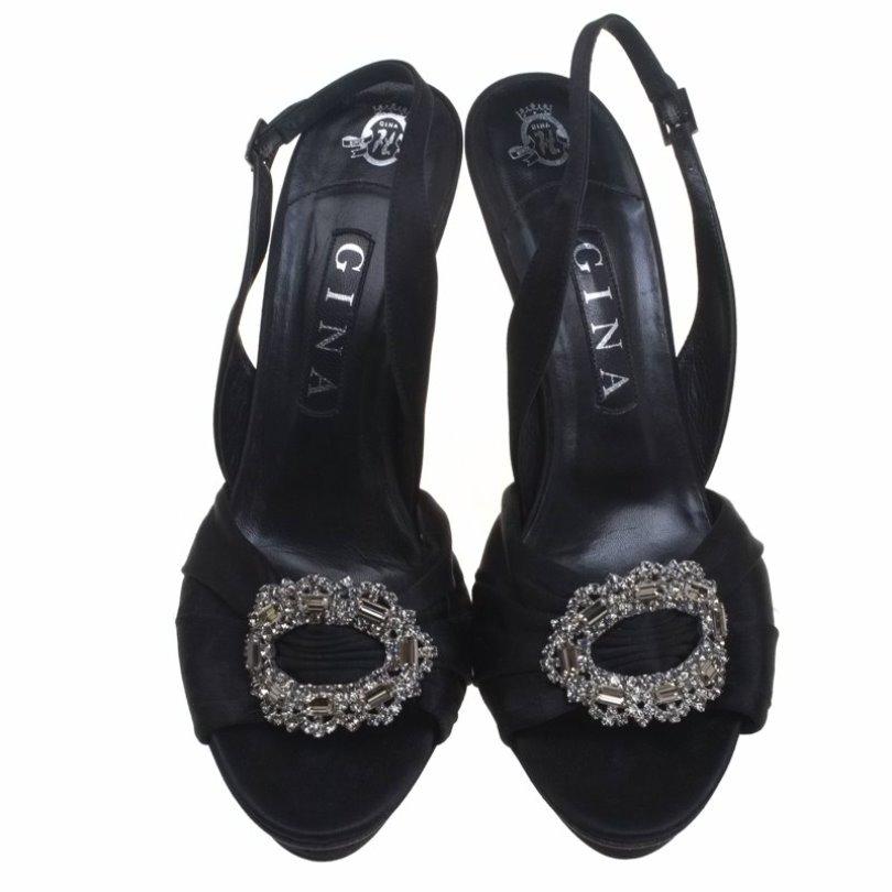 Be a trendsetter by waltzing out in this exquisite Gina pair. Crafted from satin and leather, these beauties feature stiletto heels, buckle-held slingbacks and an eye-catching brooch embellishment at the front. Slip them on over simple outfits and