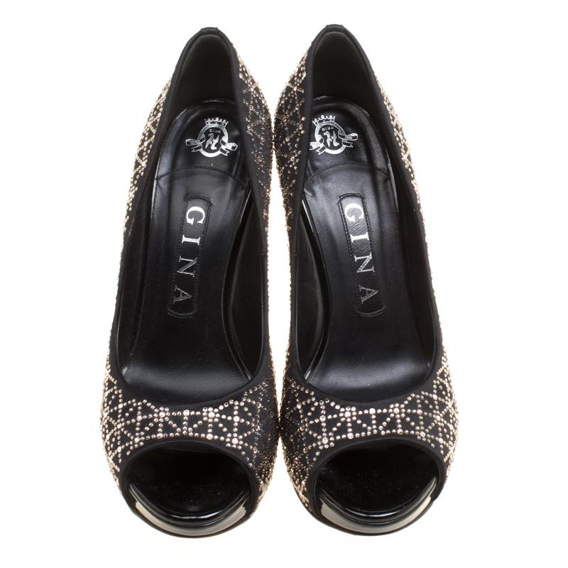 You are sure to make a mark and amaze onlookers when you step out in these stunning pumps from Gina. The black pumps are crafted from satin and feature a peep-toe silhouette. They flaunt exquisite crystals embellished all over on the exterior and