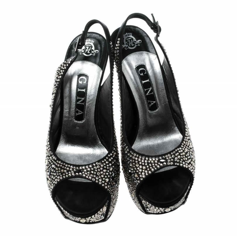 The most covetable silhouette of the season, these sandals from Gina are an instant style elevator. They feature an eye-catching crystal embellishment all over and are crafted in black satin. Set on 15 CM high stiletto heels, these sandals are