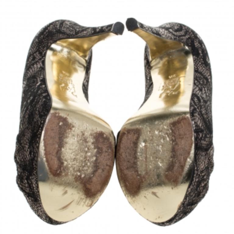 These black & silver sandals from Gina are filled with so much beauty, they make our hearts flutter. They carry round toes with pleat detailing, platforms and stunning brocade fabric exterior. The pumps are balanced on platforms and 13 cm heels.
