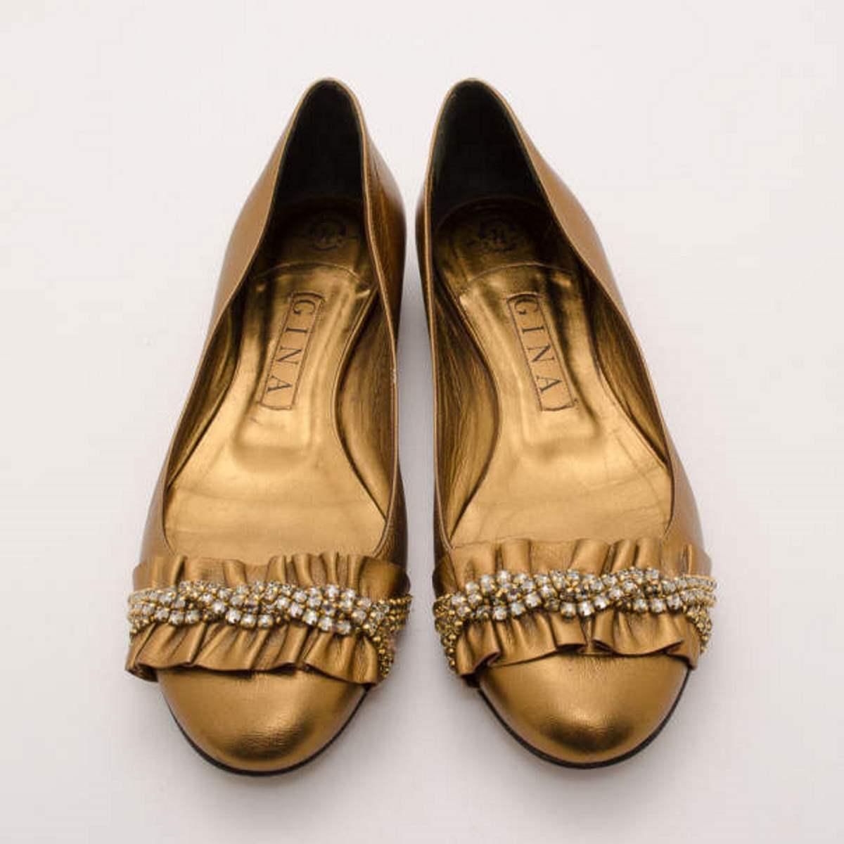 Dress up your look with these dazzling metallic embellished ballerina flats from Gina. These size 37 flats are made from metallic bronze leather with ruched leather and sparkling crystal detailed rounded toes. The insoles are lined with leather and