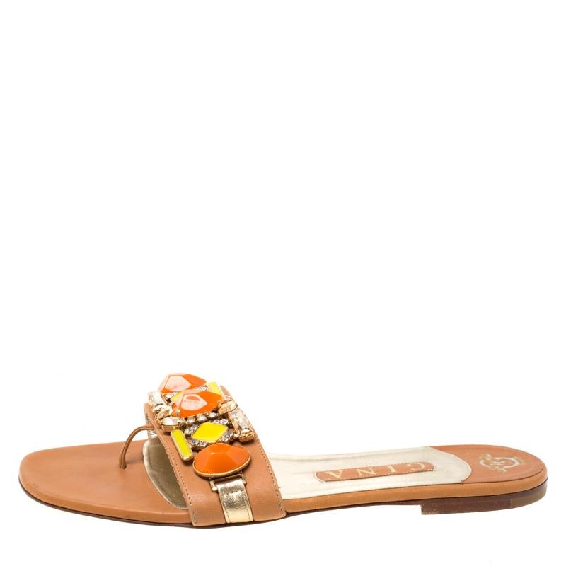 Delicate embellishments adorn these flat sandals from Gina. They are crafted from brown leather and feature colourful stones and sparkling crystals on the vamp strap. Slip them on to put a graceful spin on a host of daytime looks

Includes: The