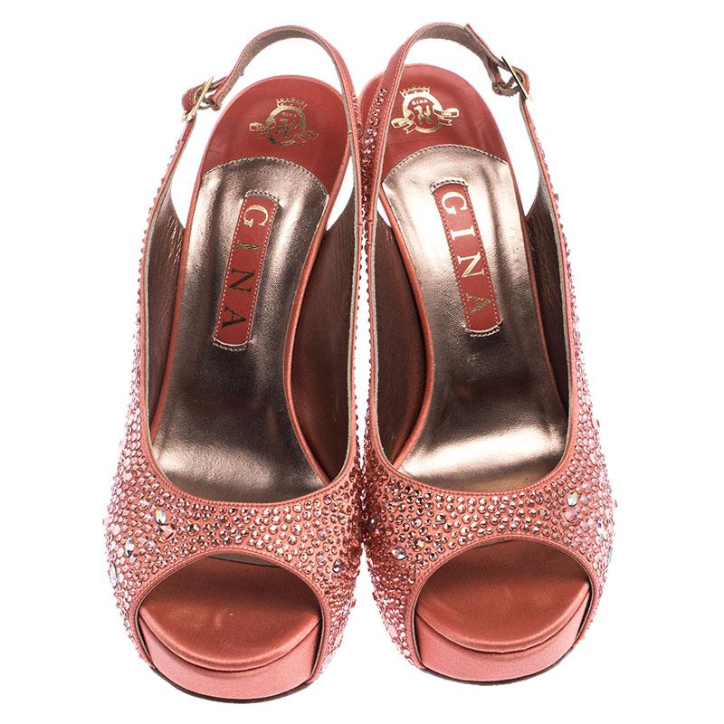 The most covetable silhouette of the season, these sandals from Gina are an instant style elevator. They feature eye-catching crystal embellishment all over and are crafted in coral orange satin. Set on 14 cm high stiletto heels, these sandals are