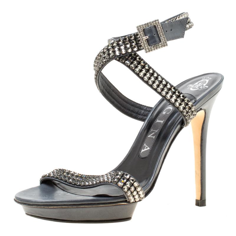Bursting with sparkles, Gina made these sandals to catch one's eye. They are designed with crystal-embellished straps across the toes and around the ankles. The sandals will give you glamour and lift you with the 12 cm heels.

