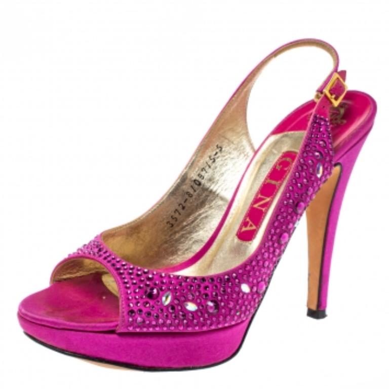 Wear these stylish sandals from the house of Gina and channel your inner fashionista. Flaunt style at its best with these beautiful satin sandals that come in a shade of fuchsia. They have open toes, platforms, jewel-embellished exterior, buckled