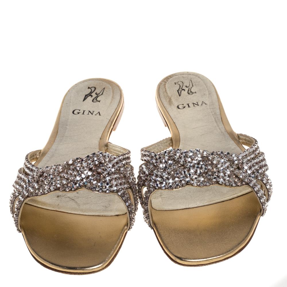 These slides from Gina are glamorous and ideal for days you do not want to wear high heels! These beauties are crafted from leather in a gold shade and feature crystal embellishments all over the straps for an opulent finish. They are complete with