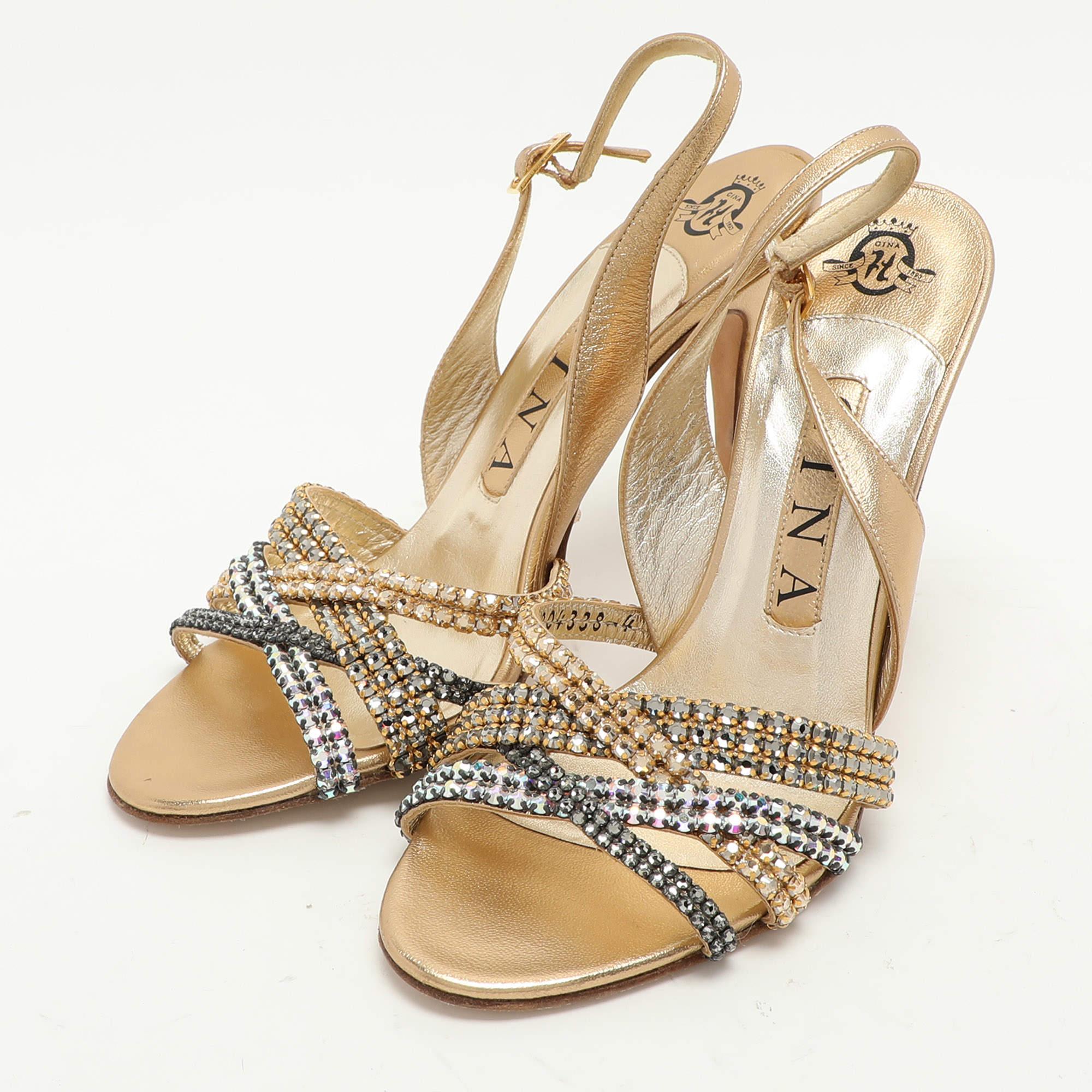 Make a stellar appearance at your next party by adorning this pair of Gina sandals. Created from gold leather the crystal embellishments on the exterior make it captivating and the 10cm heels of these shoes will lend you a smooth walk experience.