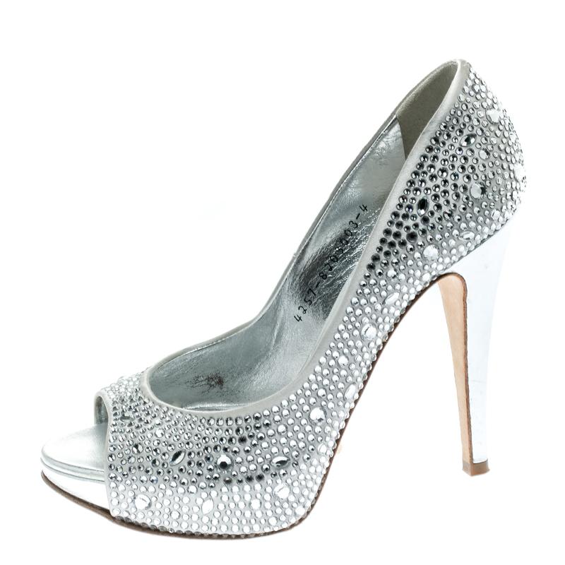 Dazzle the crowds and make the streets your fashion runway in these gorgeous sandals from Gina! These light grey sandals are crafted from satin and feature a peep-toe silhouette. They flaunt crystals embellished all over the exterior and come