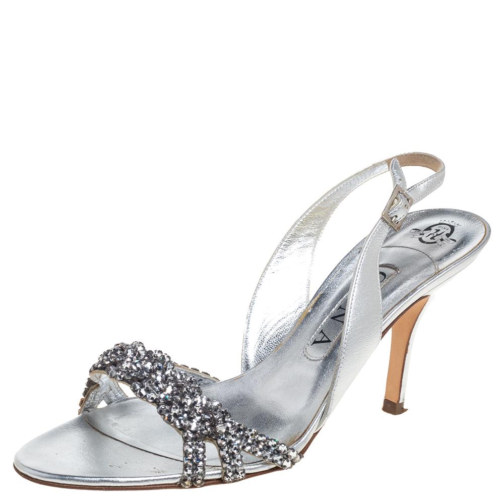 These glamorous Gina sandals look one in a million! Crafted from metallic silver leather, they come flaunting crystal-embellished vamp straps and slingbacks. They are equipped with comfortable insoles and elevated on 9 cm heels.

Includes: Original