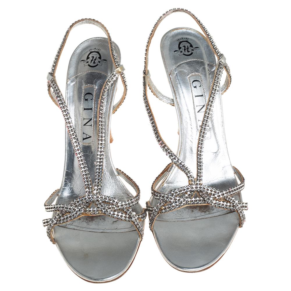 Exude glamour with these metallic silver Gina sandals. Crafted in leather, they come embellished with crystals on the strappy uppers. The slingback sandals are elevated on 10.5 cm heels.

Includes: Original Dustbag, Original Box
