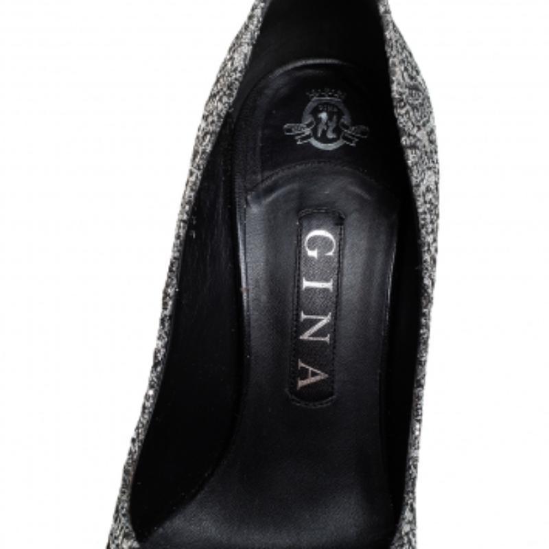 From the house of Gina, these pumps are tastefully designed. This gorgeous pair in lurex fabric and glitter will match well with your special outfits. The metallic silver pumps feature pointed toes, 11 cm heels, and comfortable leather-lined insoles.