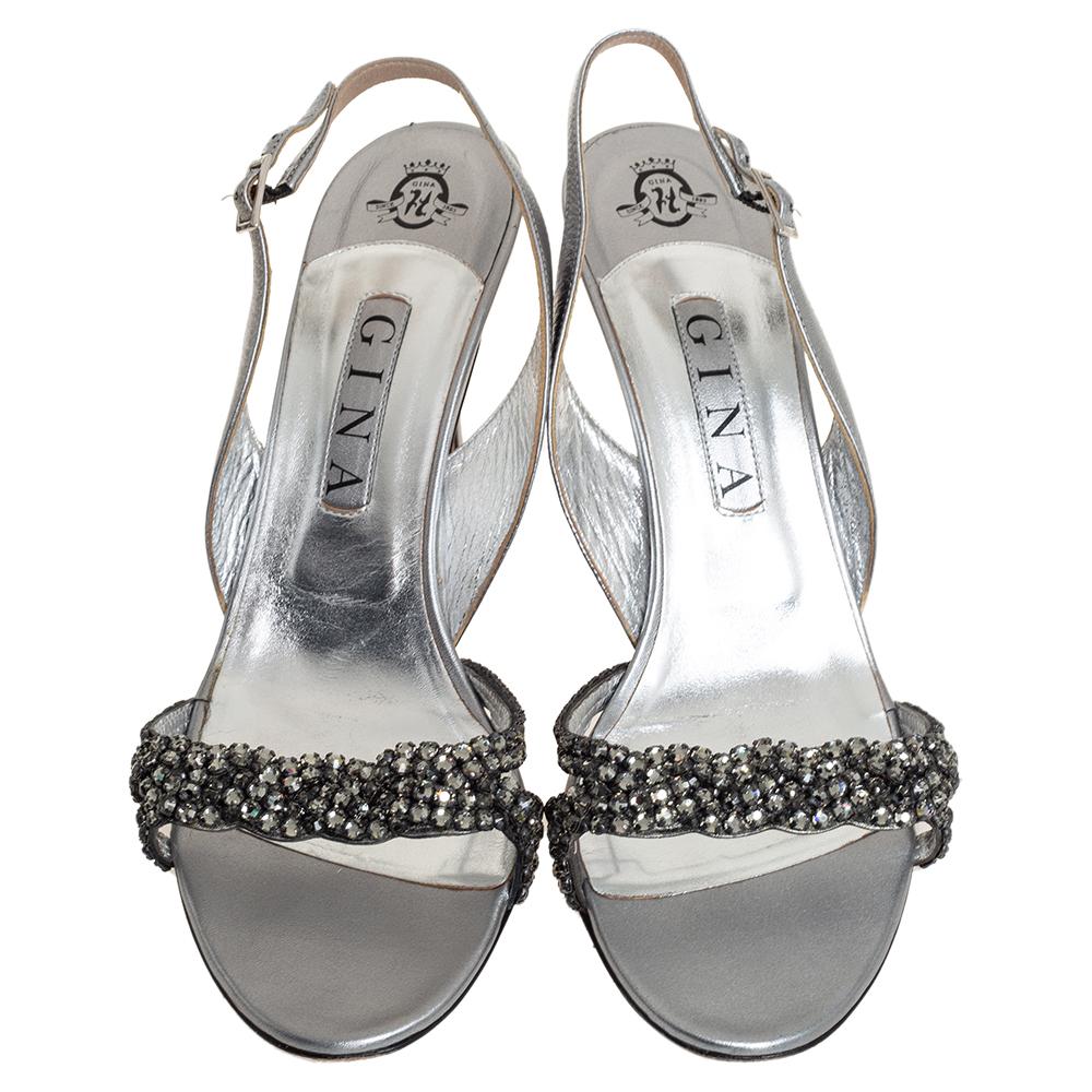 These glamorous Gina sandals look one in a million! Crafted from metallic silver leather, they come flaunting crystal-embellished vamp straps and slingbacks. They are equipped with comfortable insoles and elevated on 9 cm heels.

Includes: Original