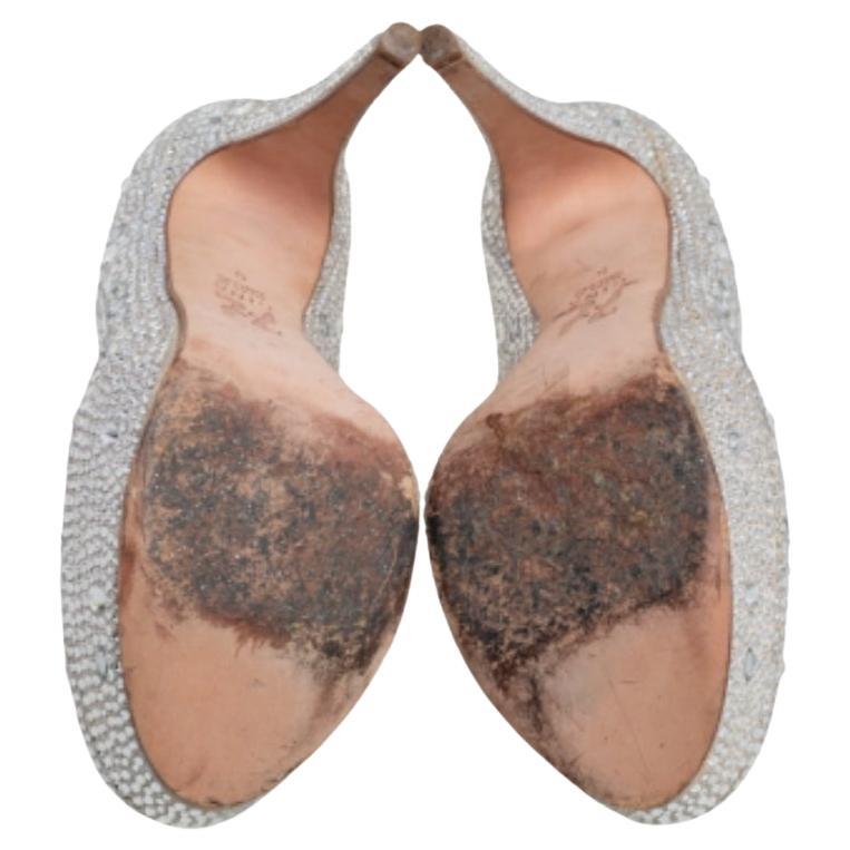 Feel like a diva in these stunning pumps from Gina that look divine. These silver pumps are crafted in rich satin and feature exquisite crystal embellishments all over. They come with 13 cm heels, platforms, and leather-lined insoles.
