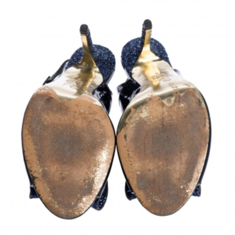 These glamorous Gina sandals look like a million bucks. Crafted in patent leather, they come with crystal-embellished bows on the vamps. Accented with 11.5 cm heels, open toes and they are equipped with slingback straps with gunmetal-tone pin