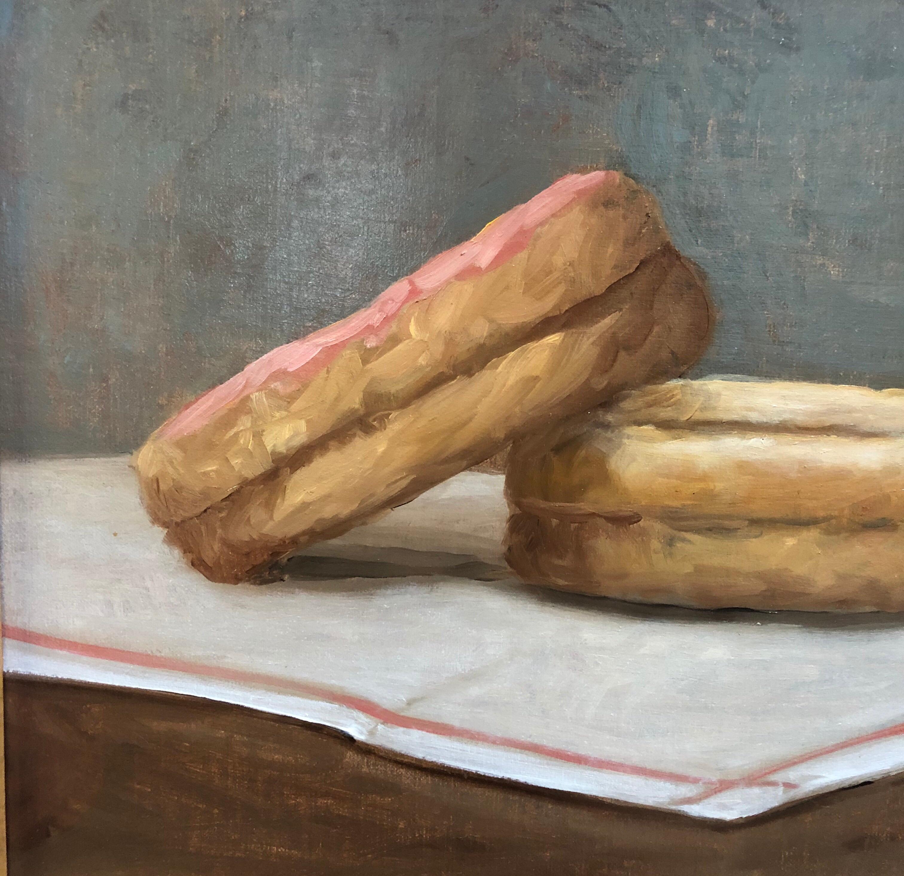 An original framed oil painting of two donuts on a tea towel, evoking a lazy Sunday morning with treats.

GC Williams has a BA in art history and began her artistic career as a self-taught artist. She subsequently studied at several classical