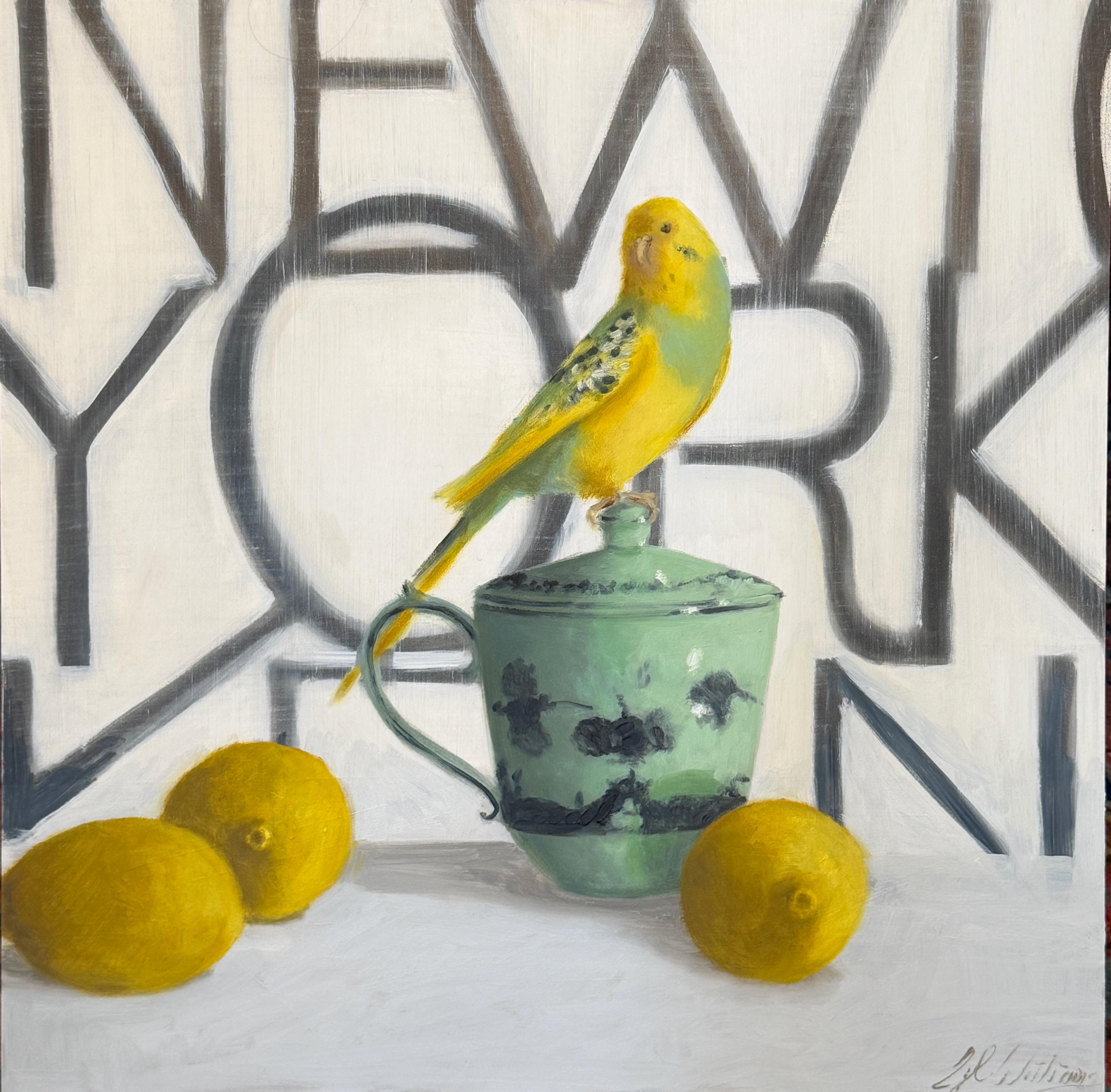 Ginny Williams brings wit and charm to Lucky and the New Yorker, a contemporary still life infused with bold pops of color. A bright yellow parakeet perches proudly atop a celadon-green teacup, flanked by three sunlit lemons that echo the bird’s