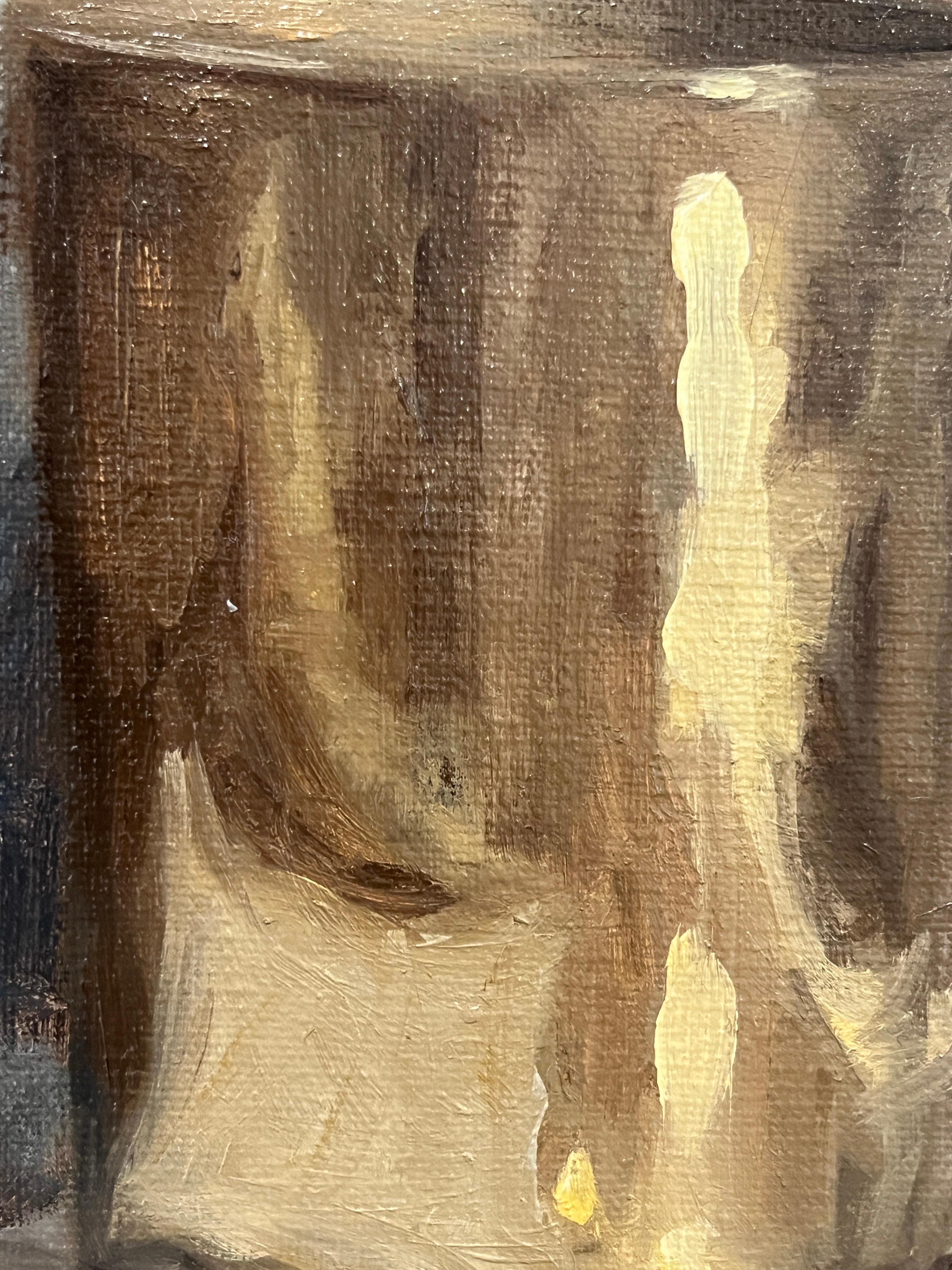 An original oil painting on panel by artist Ginny Williams. This moody still life features a Spode pitcher, a gold cup, books and paper. The slanting light and scrap of paper pinned to the wall add an aura of mystery. This piece is framed in a