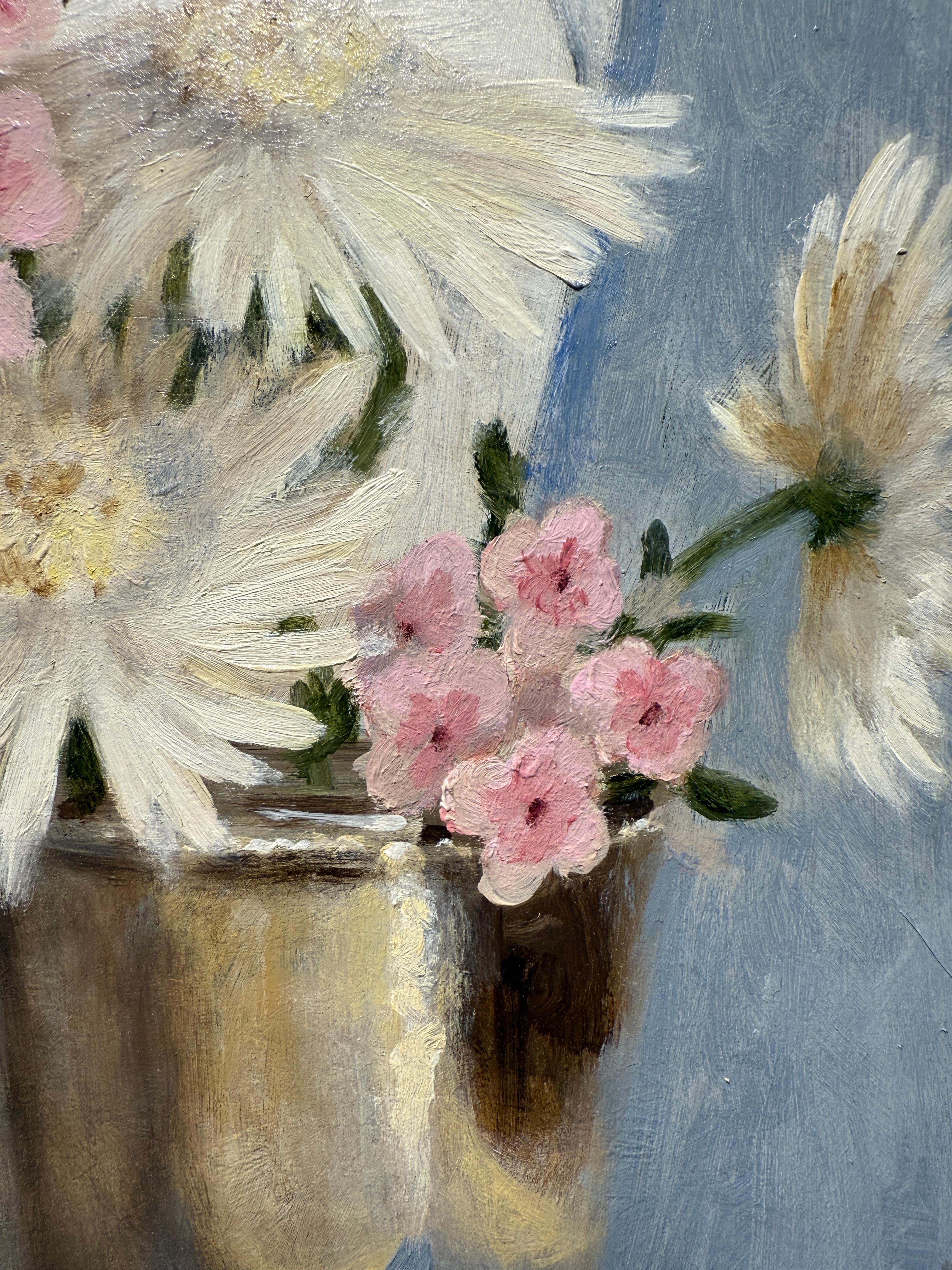 This piece is an original oil painting on panel. It features a colorful bouquet of flowers in a silver cup. A blue and white fabric patterns the background. The piece is framed in a pale gold frame, made in Italy. overall measurements are
