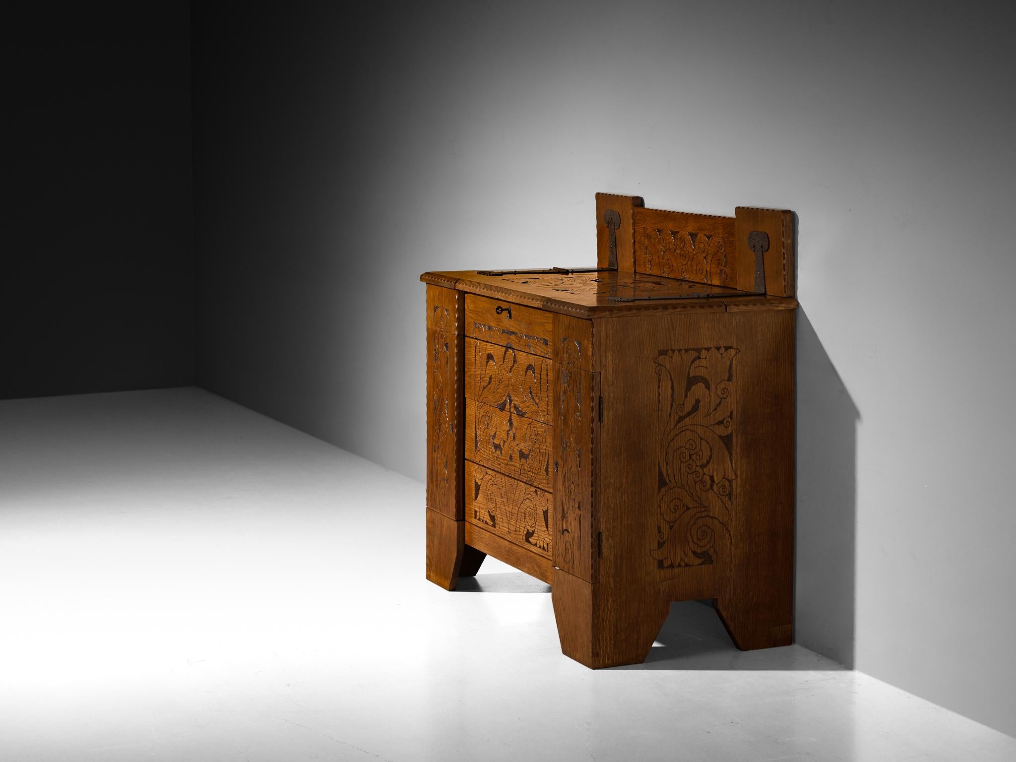 Iron Gino Maggioni for Atelier di Varedo 1920s Chest of Drawers in Carved Oak For Sale