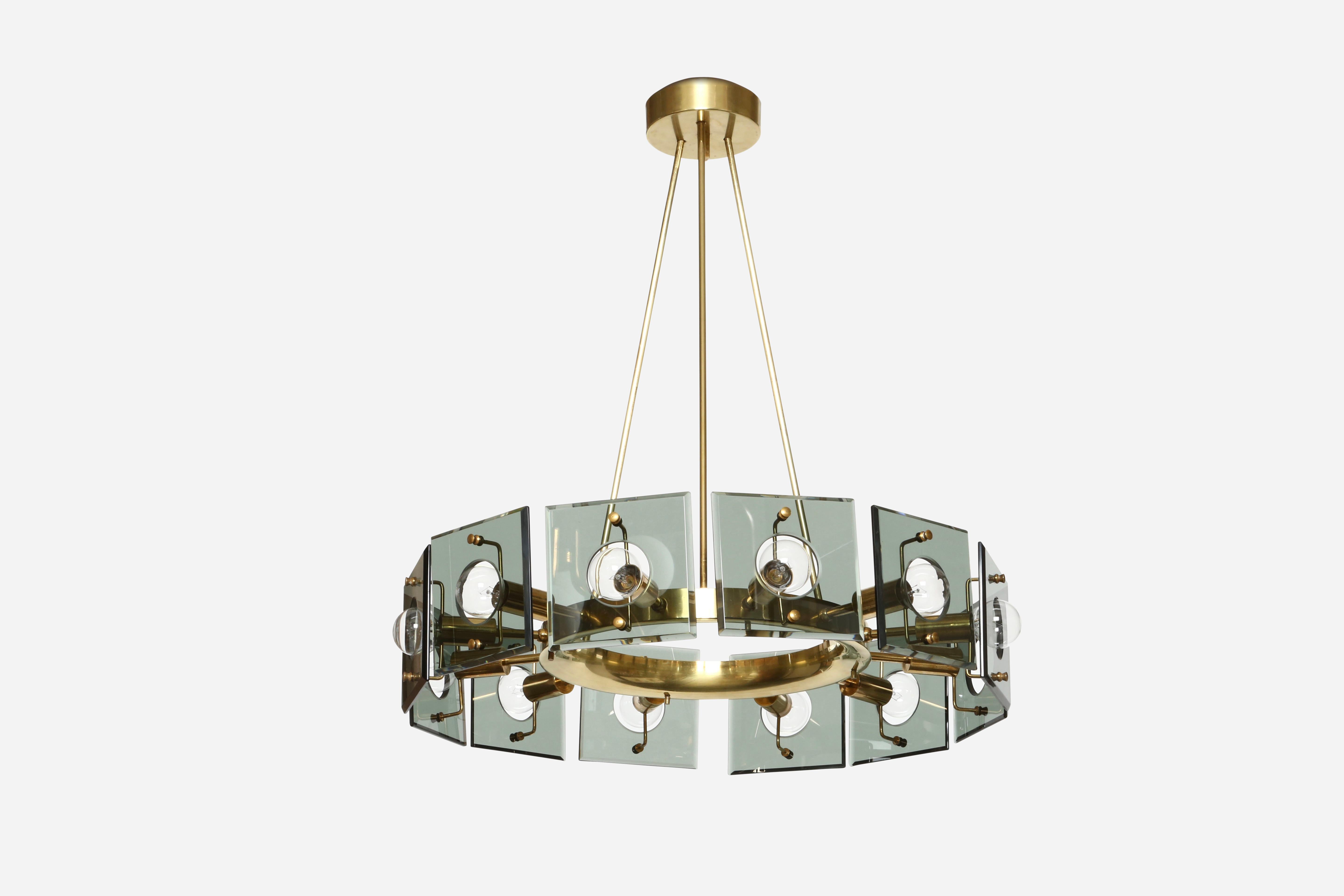 Chandelier by Gino Paroldo.
Designed and made in Italy in 1960s.
Brass frame and crystal glass.
12 Candelabra base sockets.
Complimentary US rewiring upon request.
Height adjustable, stems can be shortened.
 