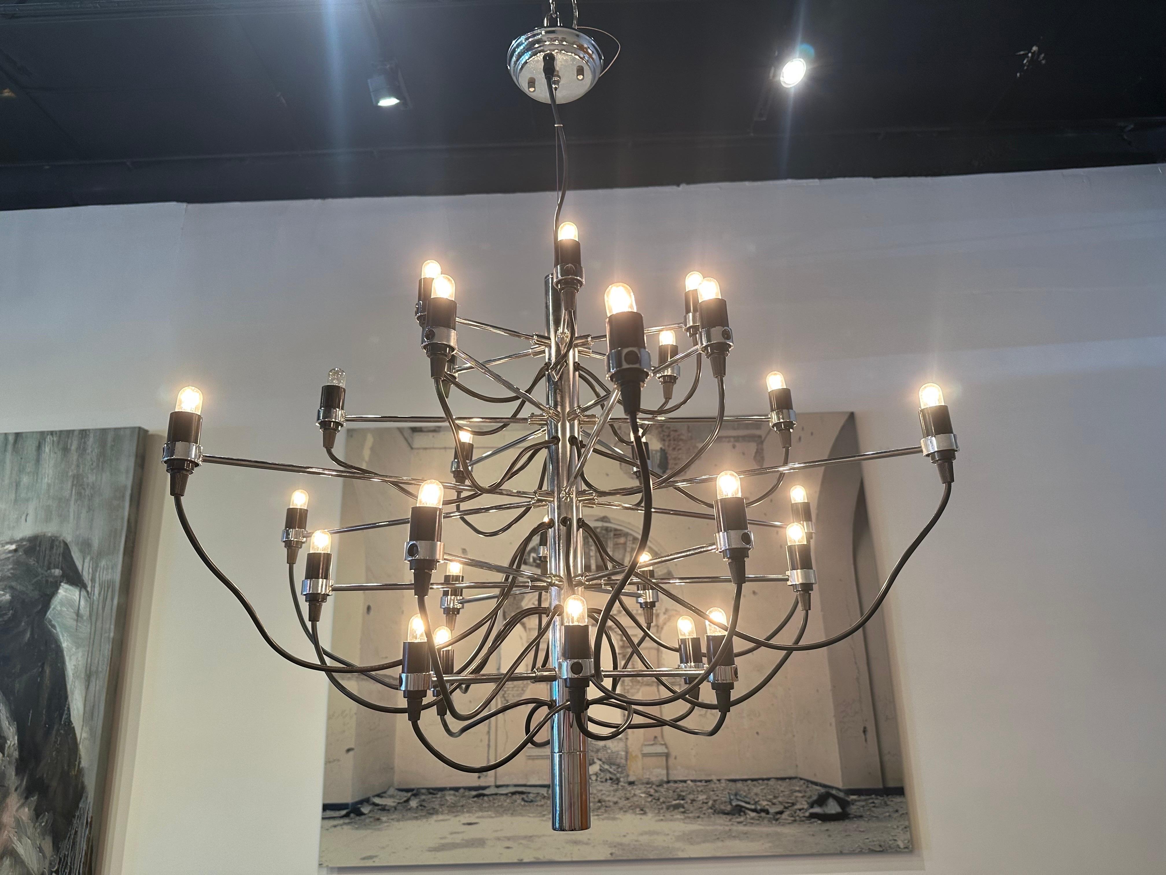 Designed originally in 1958, this iconic Gino Sarfatti chandelier has served as an ultra-modern representation of the traditional midcentury style.  Every detail of this state-of-the-art ceiling light is exceptional, from the mirror-polish of its