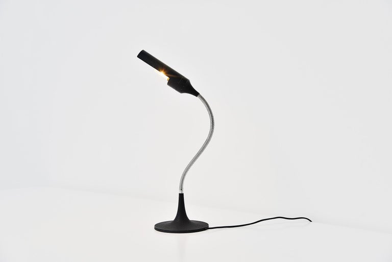 Sculptural and adjustable table lamp model 595 designed by Gino Sarfatti and manufactured by Arteluce, Italy 1961. Guard reflector in black painted aluminium, swiveling on a chrome plated sleeve. Flexible stem in chrome plated brass. Trumper shaped