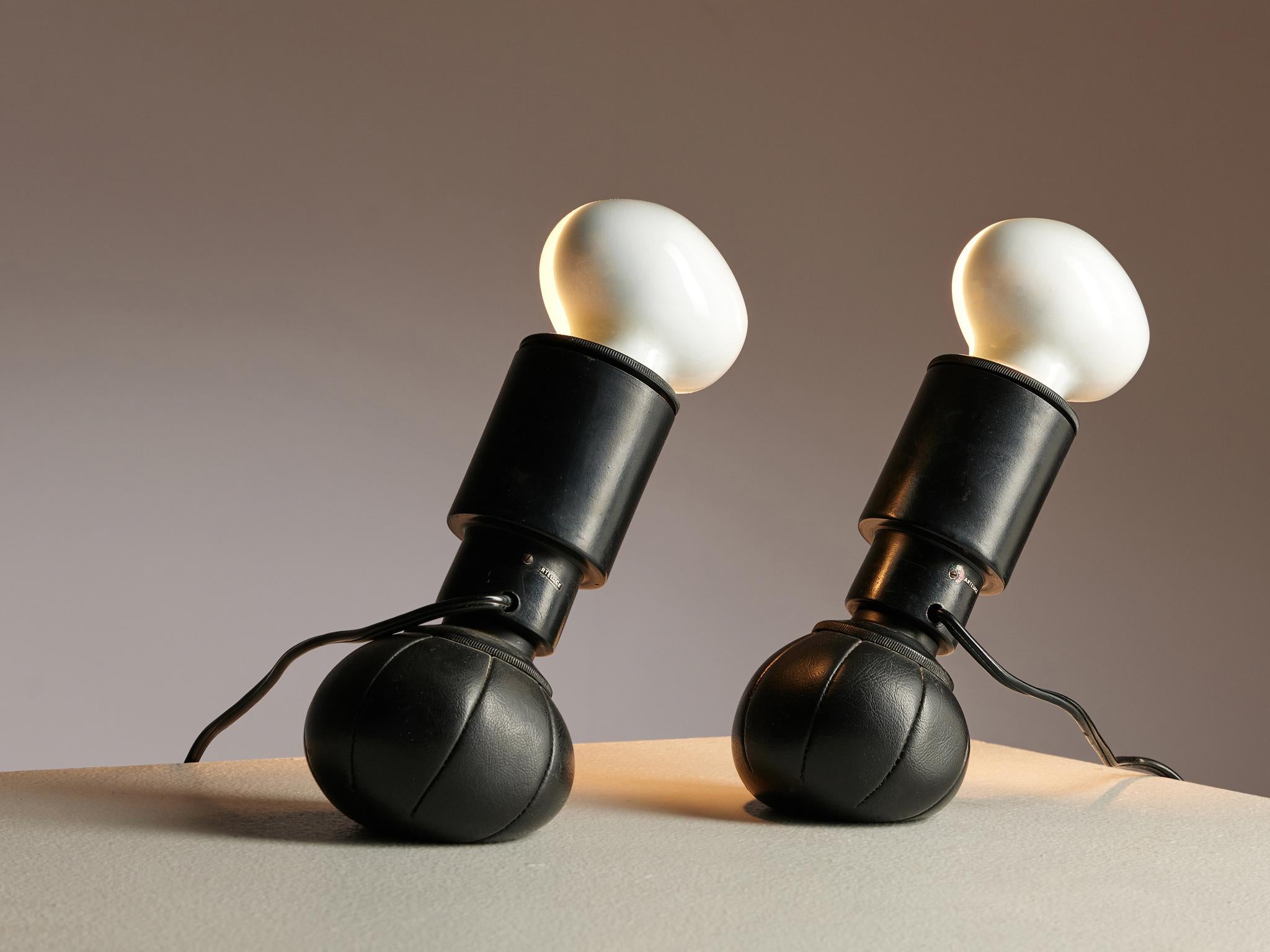 Gino Sarfatti for Arteluce, 600/c table lamps, made in lacquered aluminum and leather, Italy, 1966.

A set of exceptional lights with weights at the bottom as if made with bean bags. The weights that resemble a ball, keep the lights in their place,
