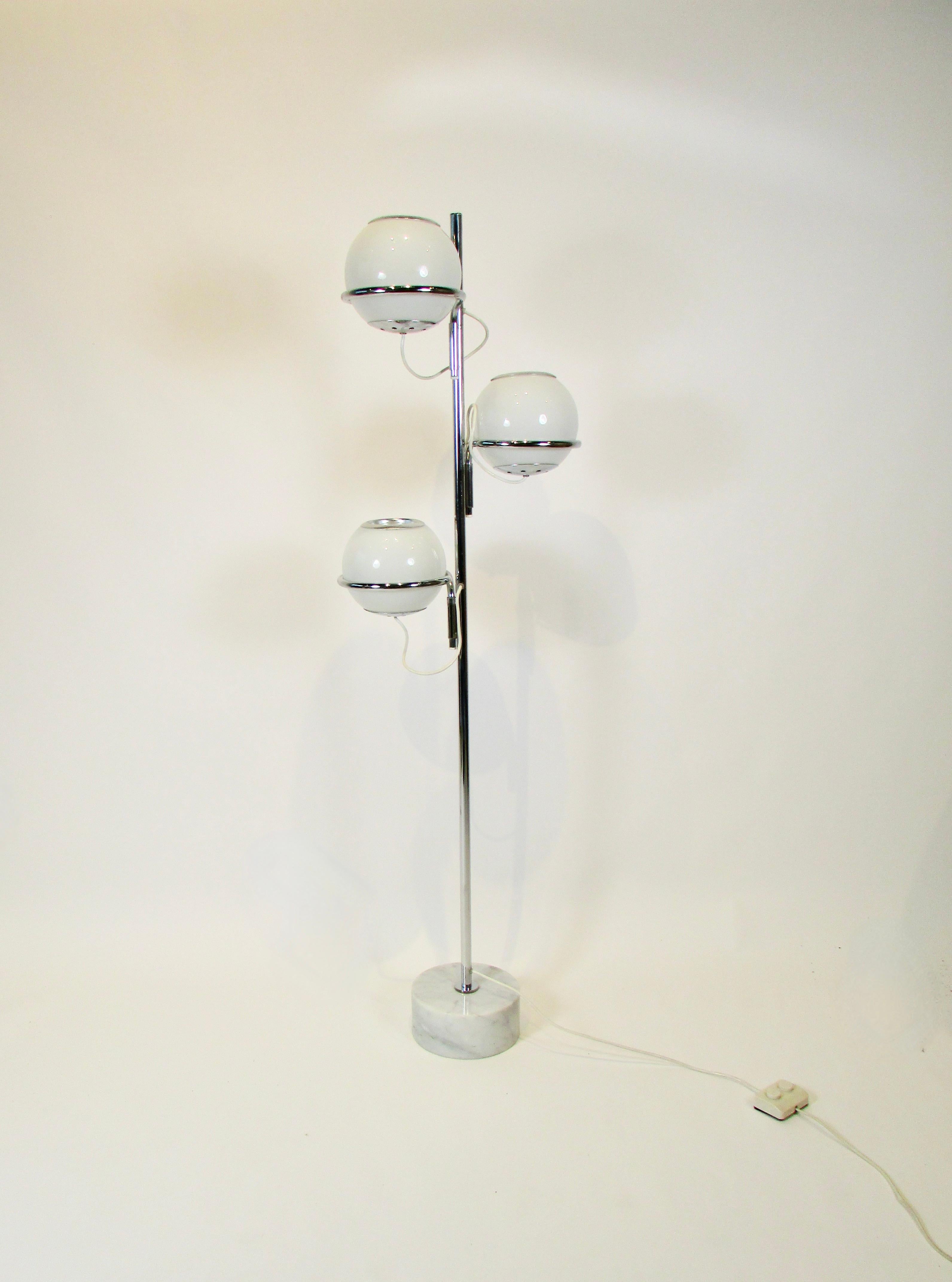 Multi adjustable floor lamp designed by Gino Sarfatti for Arteluce Italy . Three globes which rotate in every direction mounted in swivel lasso brackets on chrome shaft  attached to 4