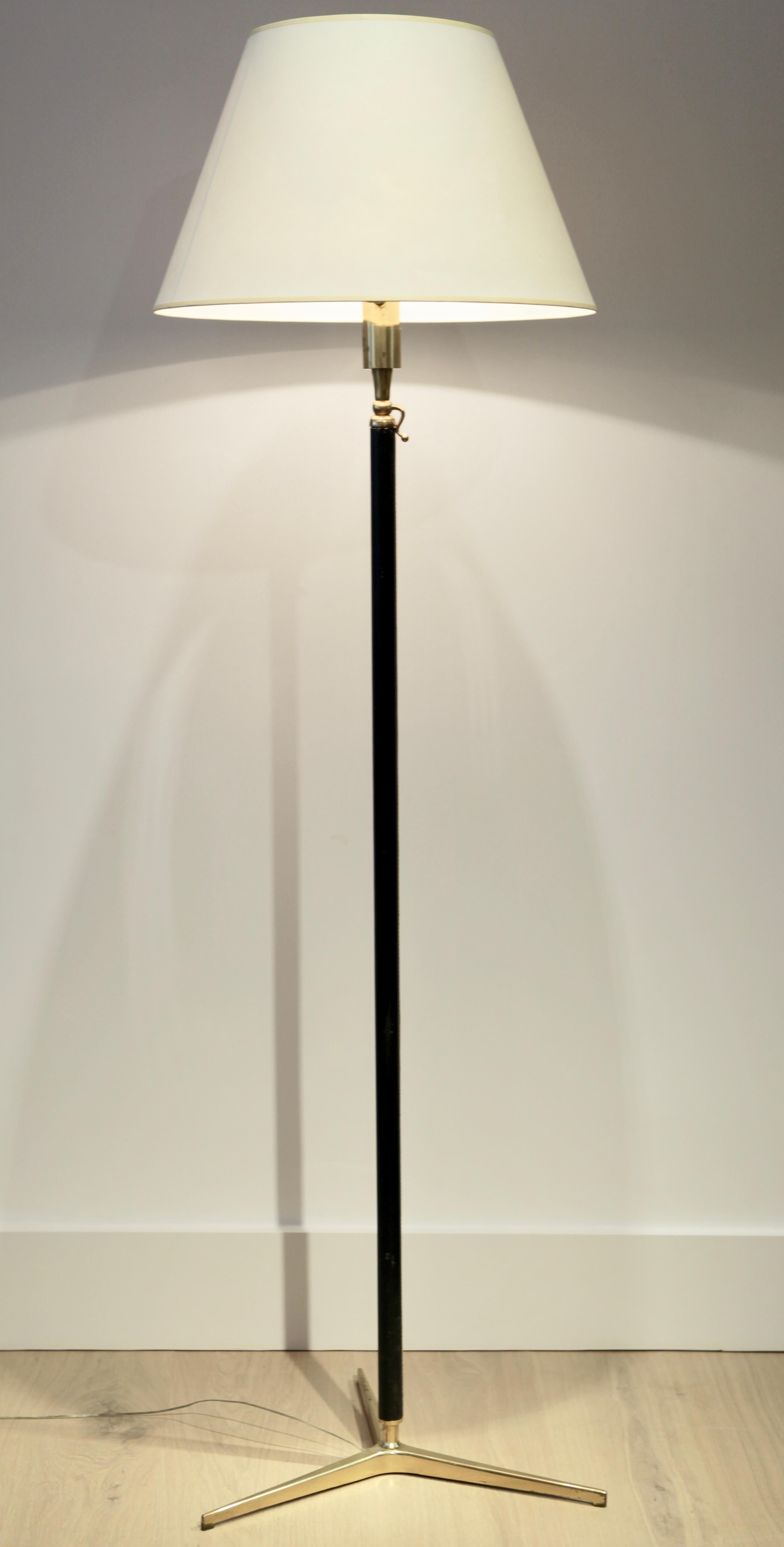 A leather and brass floor lamp attributed to Gino Sarfatti. Model 1025
Adjustable tubular brass stem, black leather wrapped, brass tripod base.
White card shade.
 